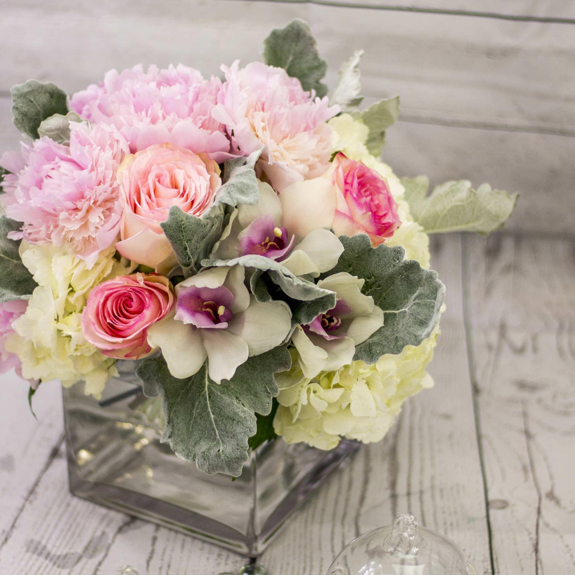 Elegant Flower Arrangement in cube clear vase will be great flower present