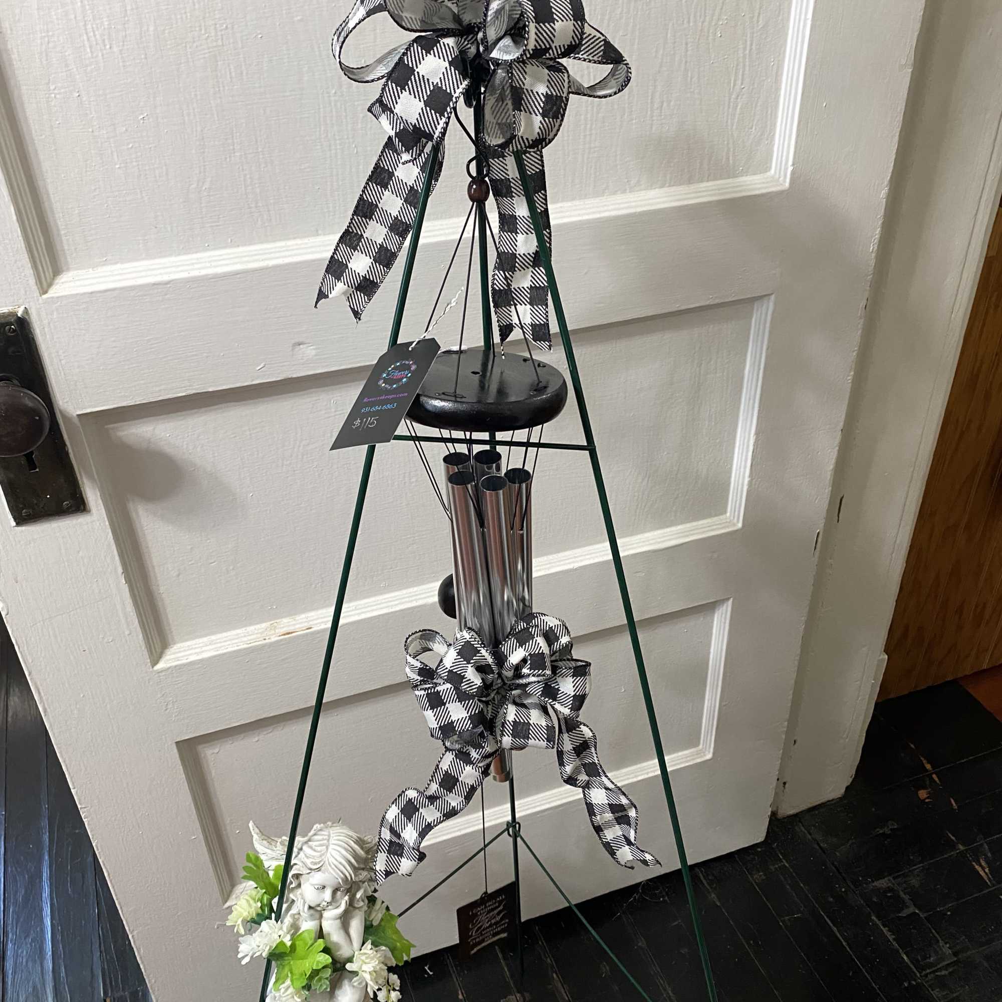 Inspirational grouping of a resin angel and a wind chime features aluminum