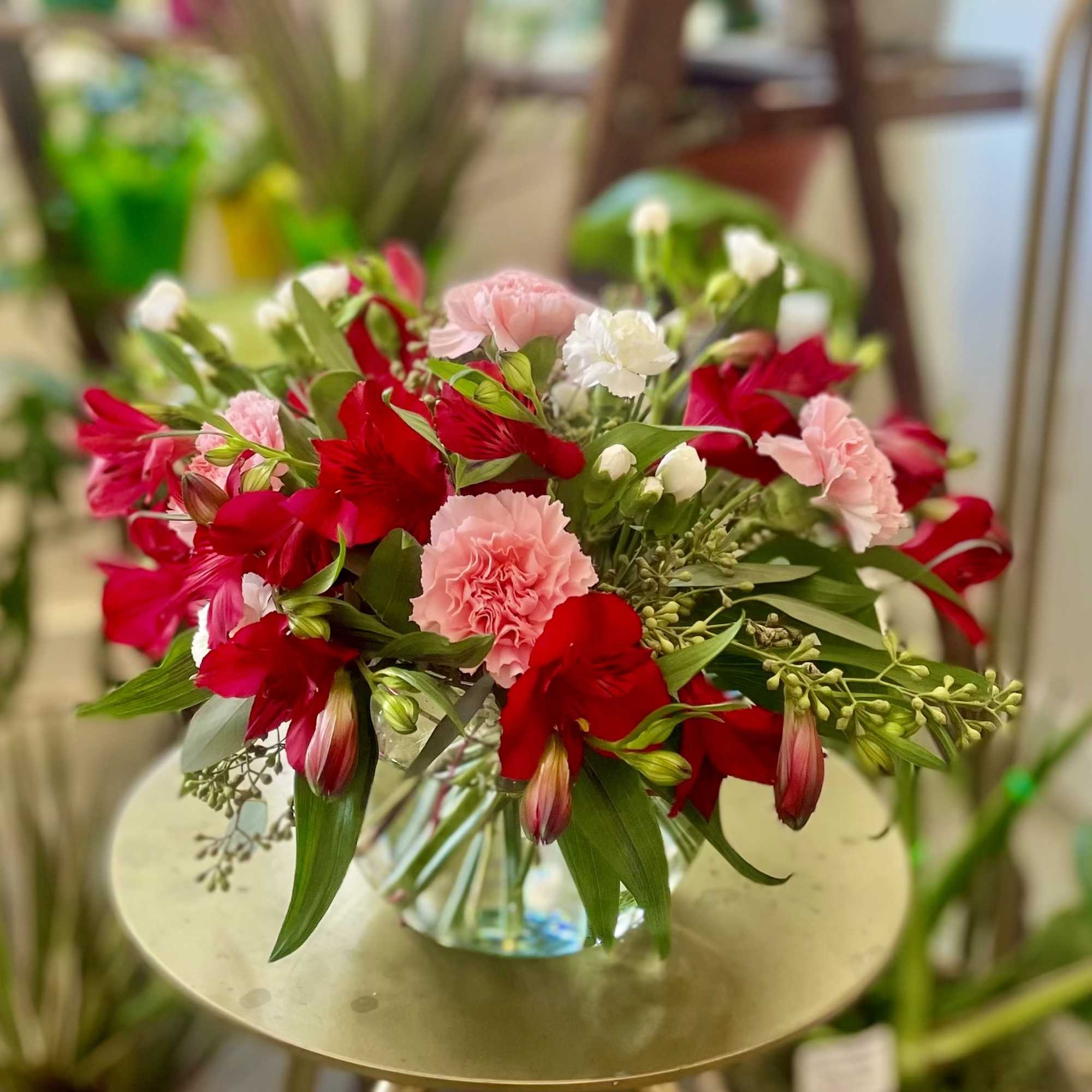 A mixture of our favorite bright flowers, in a lovely glass bubble A mixture of our favorite bright flowers, in a lovely glass bubble