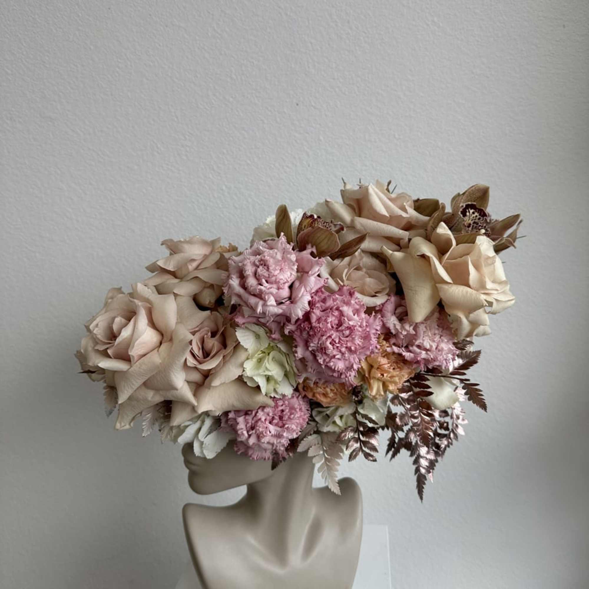 This beautiful arrangement is filled with beige roses, hydrangeas and greens to