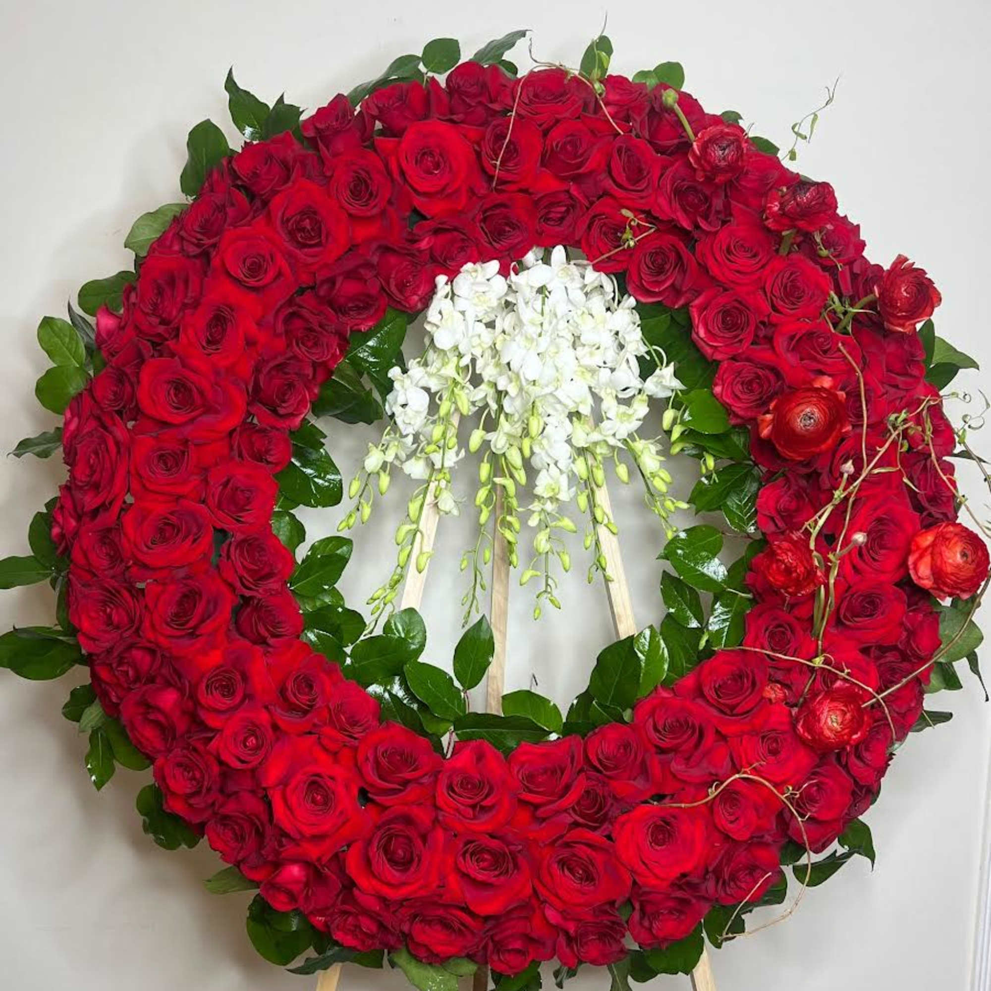 This dramatic and luxurious wreath combines the timeless beauty of red roses This dramatic and luxurious wreath combines the timeless beauty of red roses