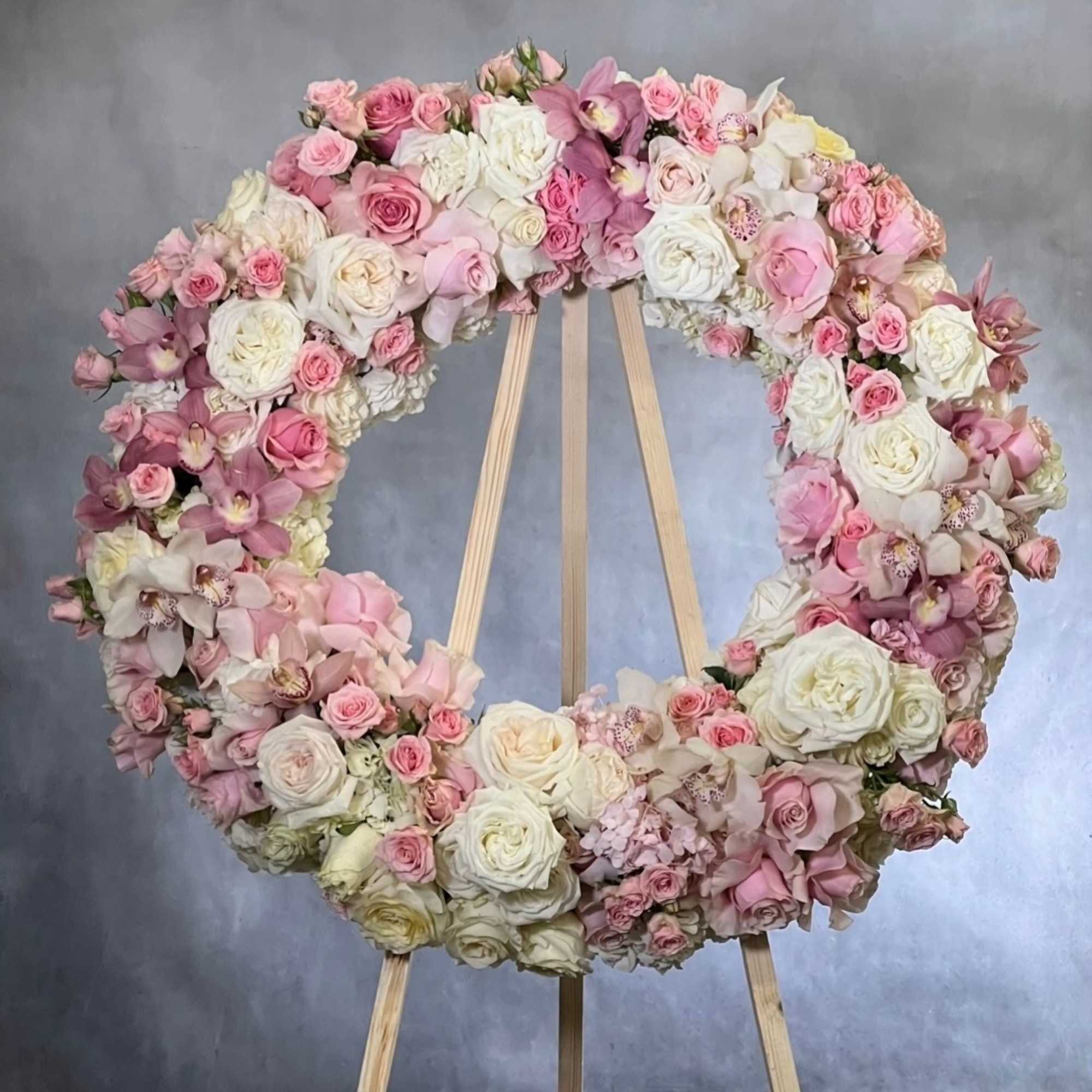 This elegant wreath arrangement is crafted from a beautiful array of soft This elegant wreath arrangement is crafted from a beautiful array of soft