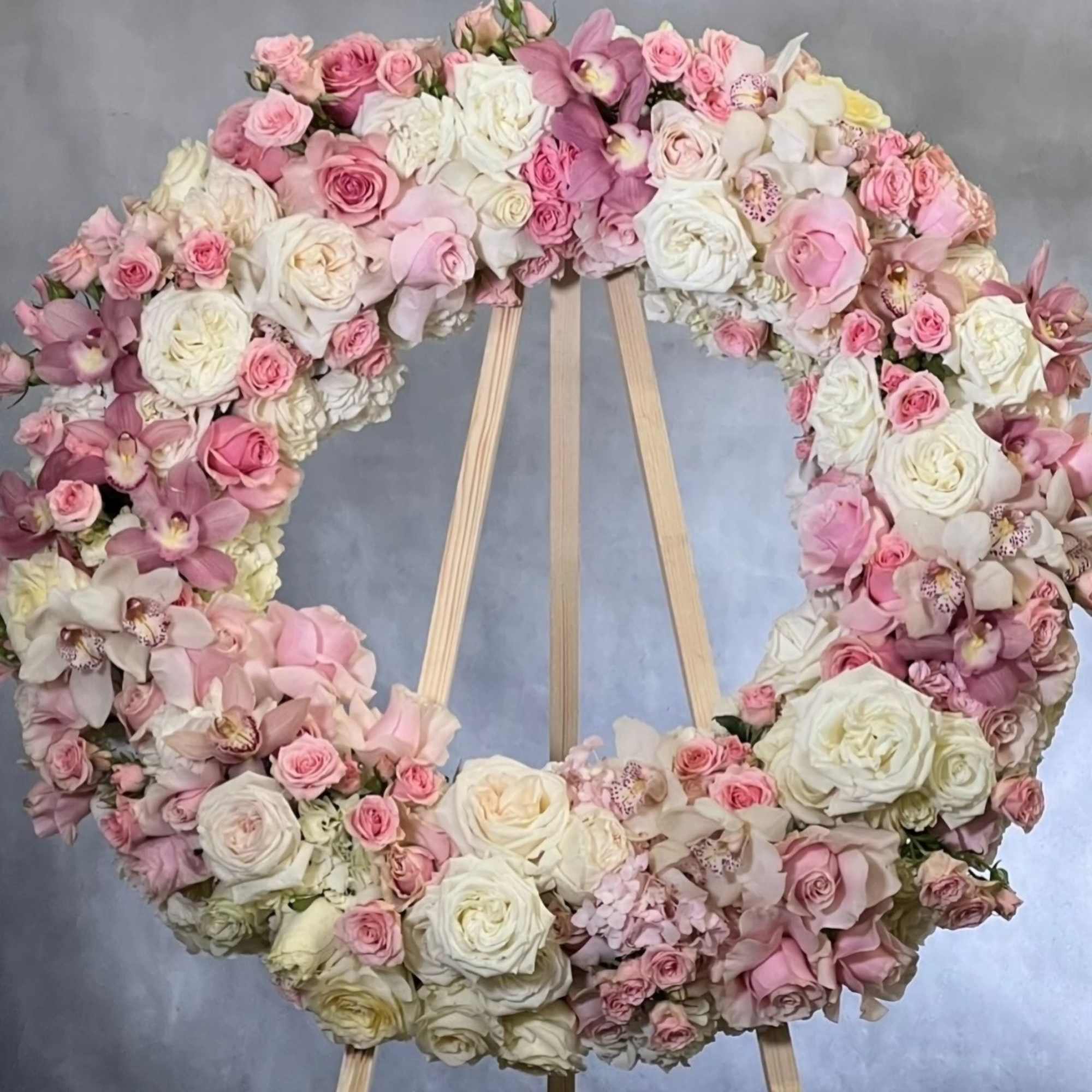This elegant wreath arrangement is crafted from a beautiful array of soft This elegant wreath arrangement is crafted from a beautiful array of soft