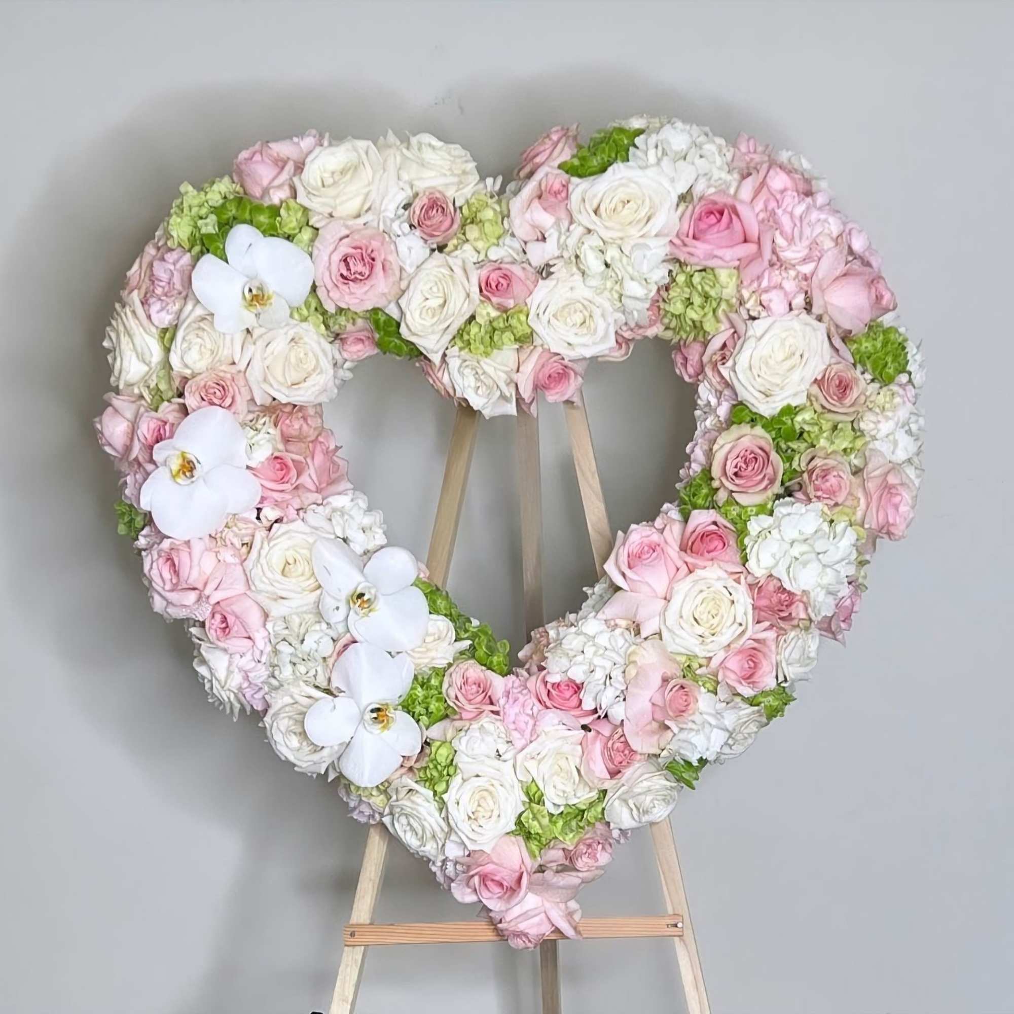 This heart-shaped arrangement is a touching tribute made with a harmonious blend This heart-shaped arrangement is a touching tribute made with a harmonious blend