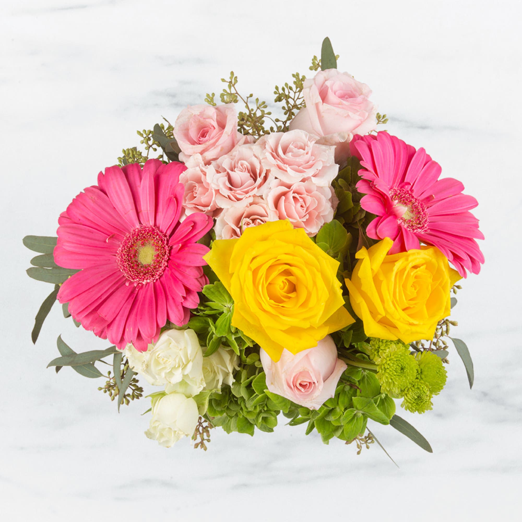 This cheerful arrangement is composed of pink gerbera daisies, roses and hydrangeas. This cheerful arrangement is composed of pink gerbera daisies, roses and hydrangeas.