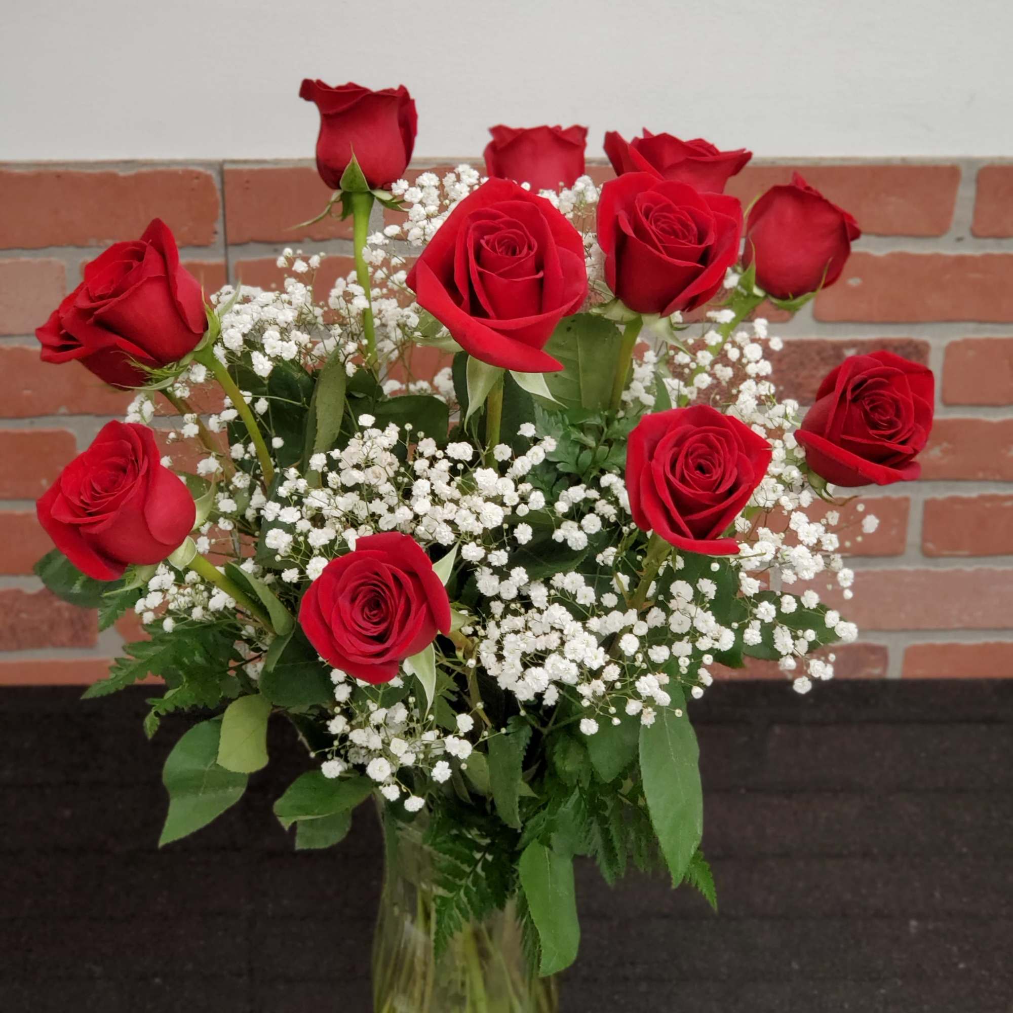 These dozen red roses with baby&#039;s breath are classic! Perfect romantic gift
