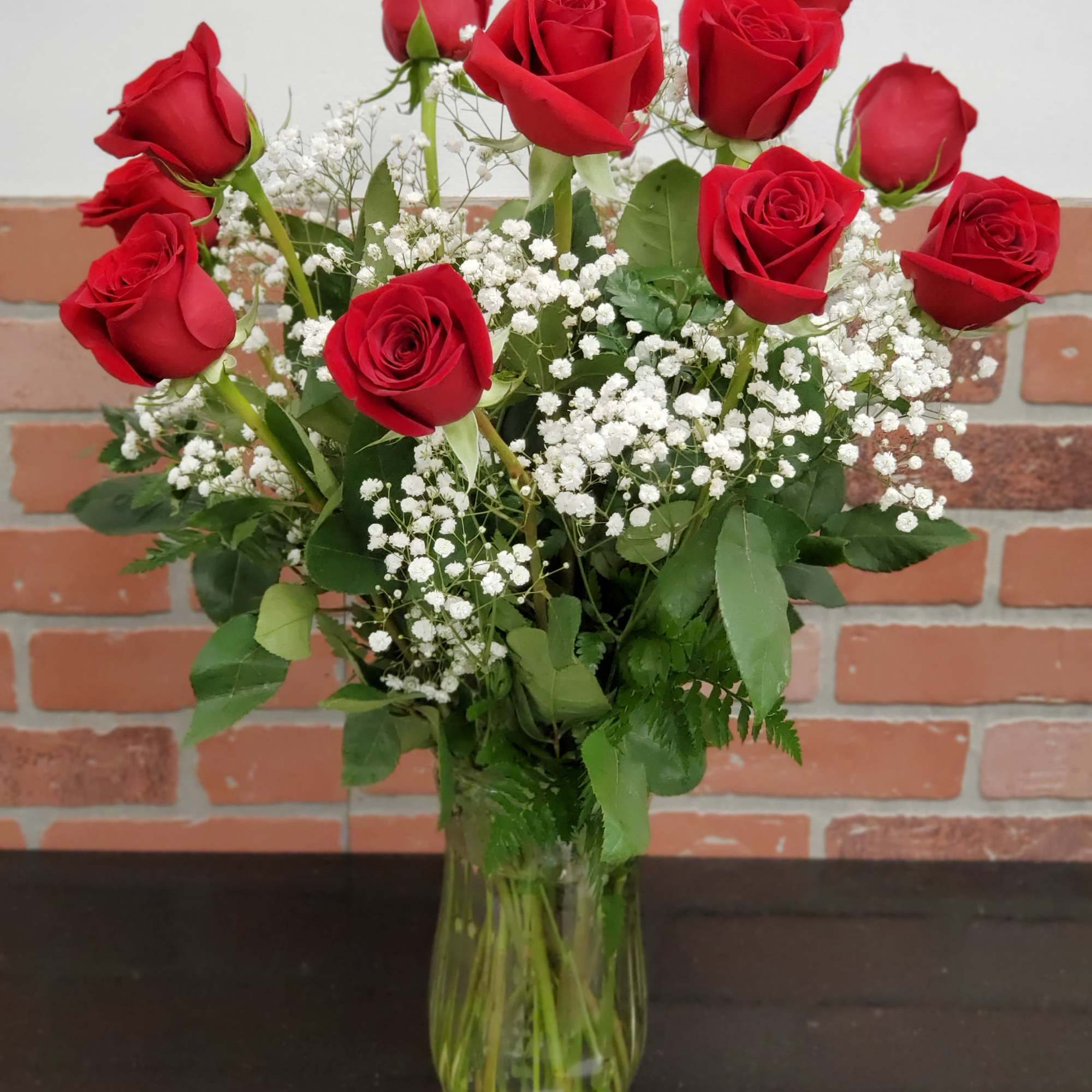 These dozen red roses with baby&#039;s breath are classic! Perfect romantic gift