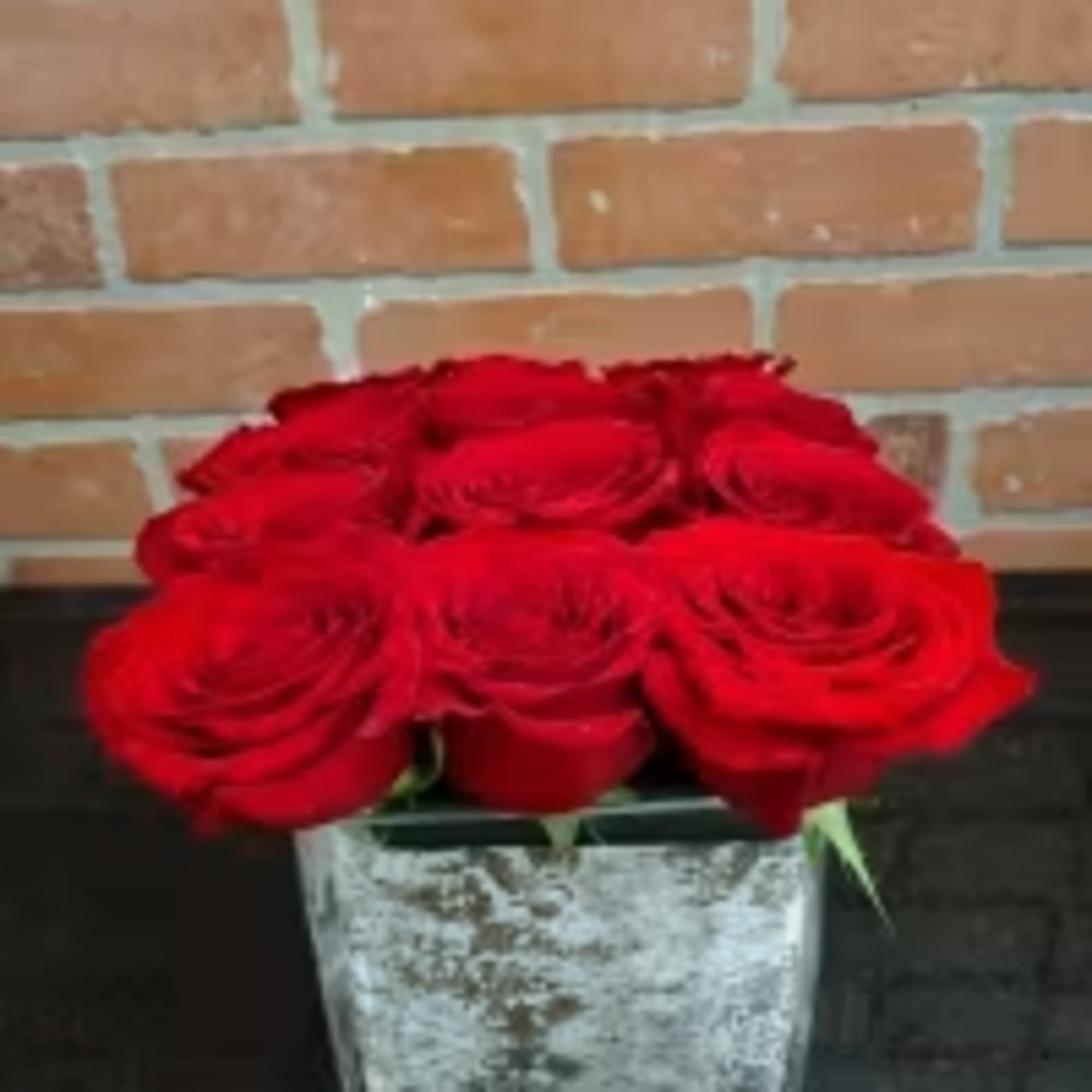 This eye-catching arrangement offers a modern twist on the classic dozen. Rustic