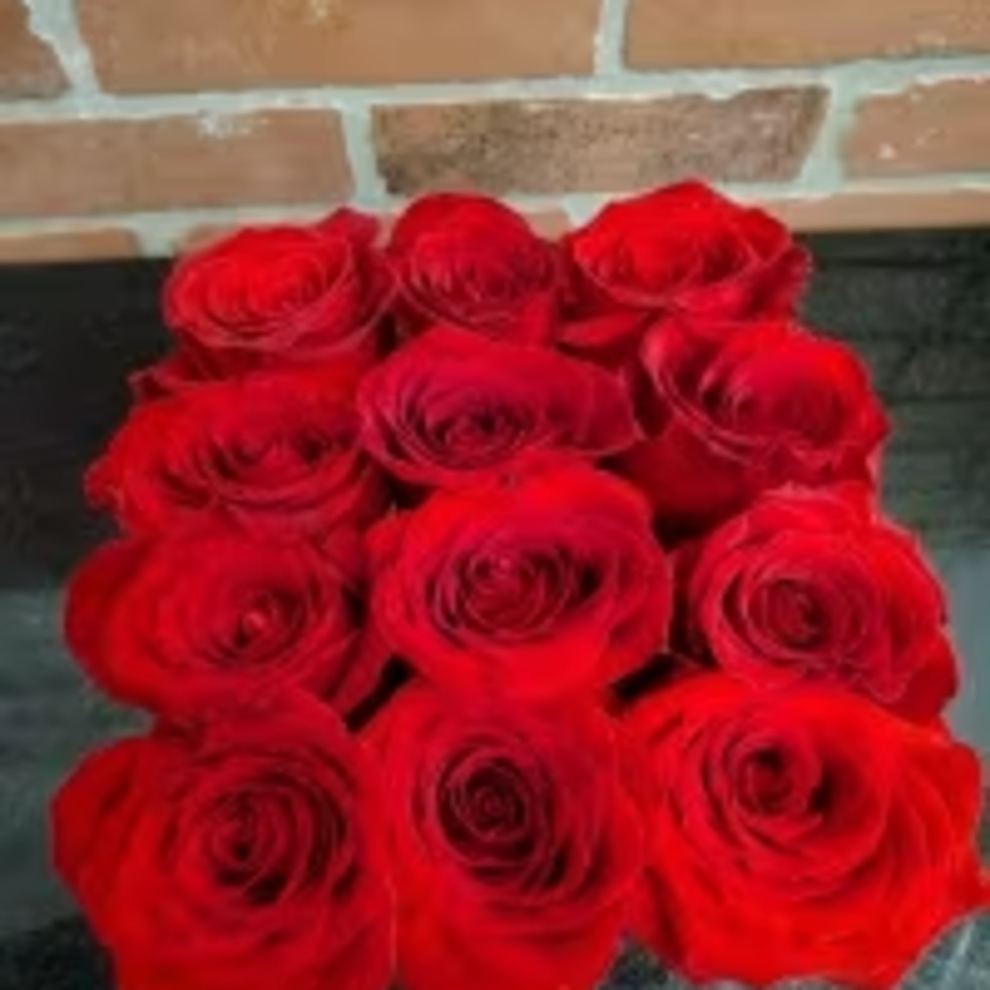 This eye-catching arrangement offers a modern twist on the classic dozen. Rustic