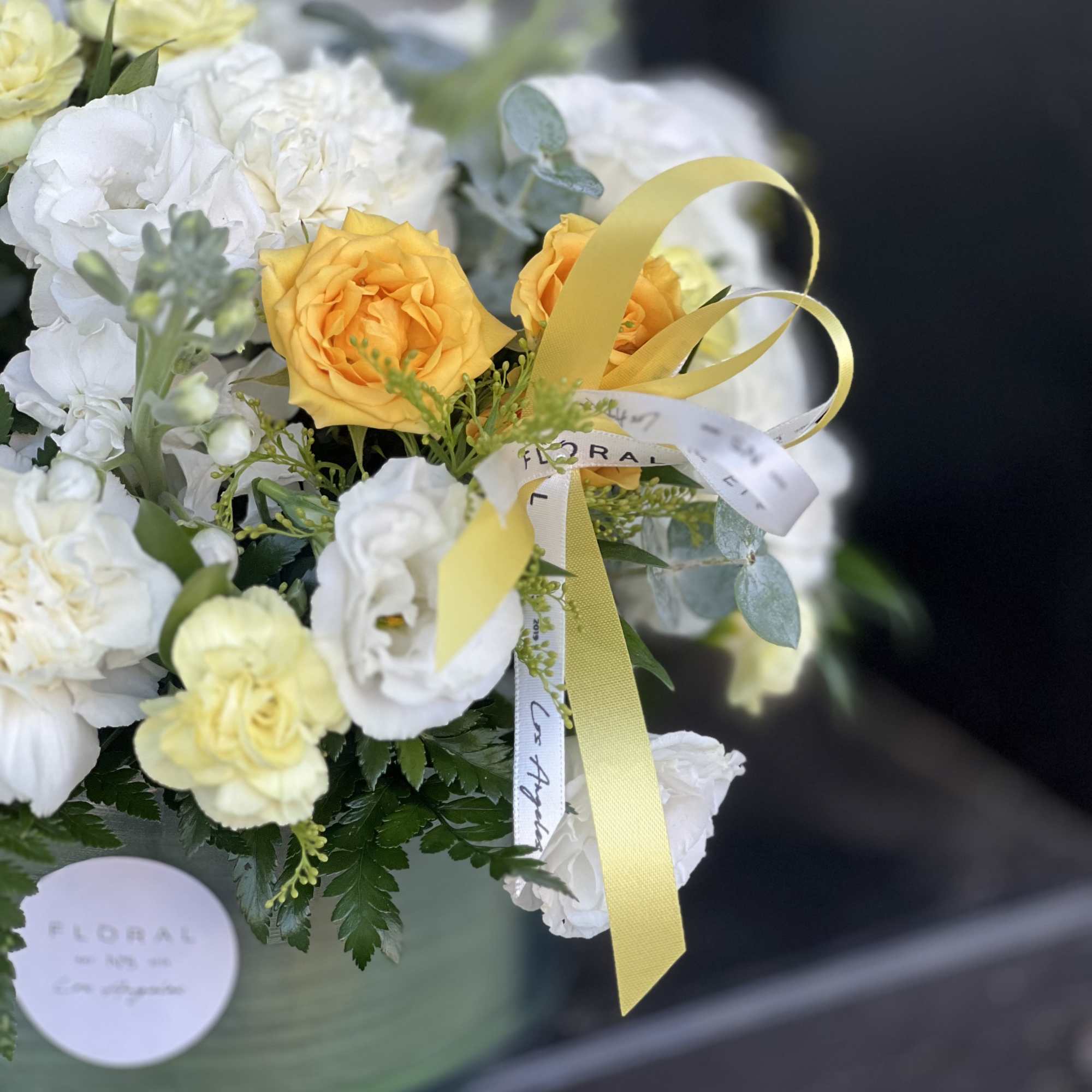 A modern take on floral gifting, this mixed white and yellow arrangement