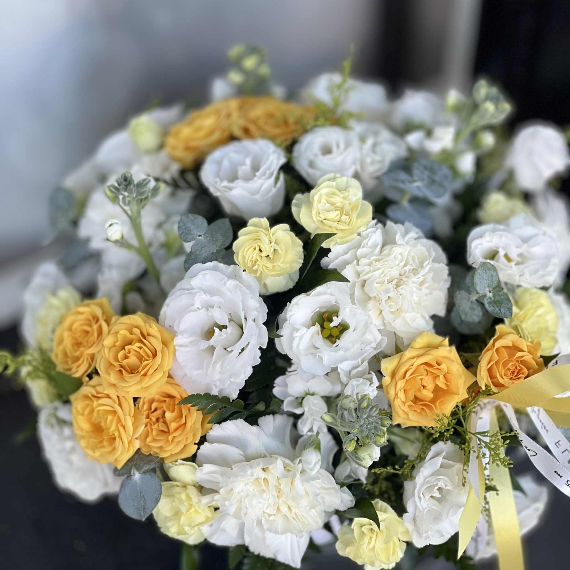 A modern take on floral gifting, this mixed white and yellow arrangement