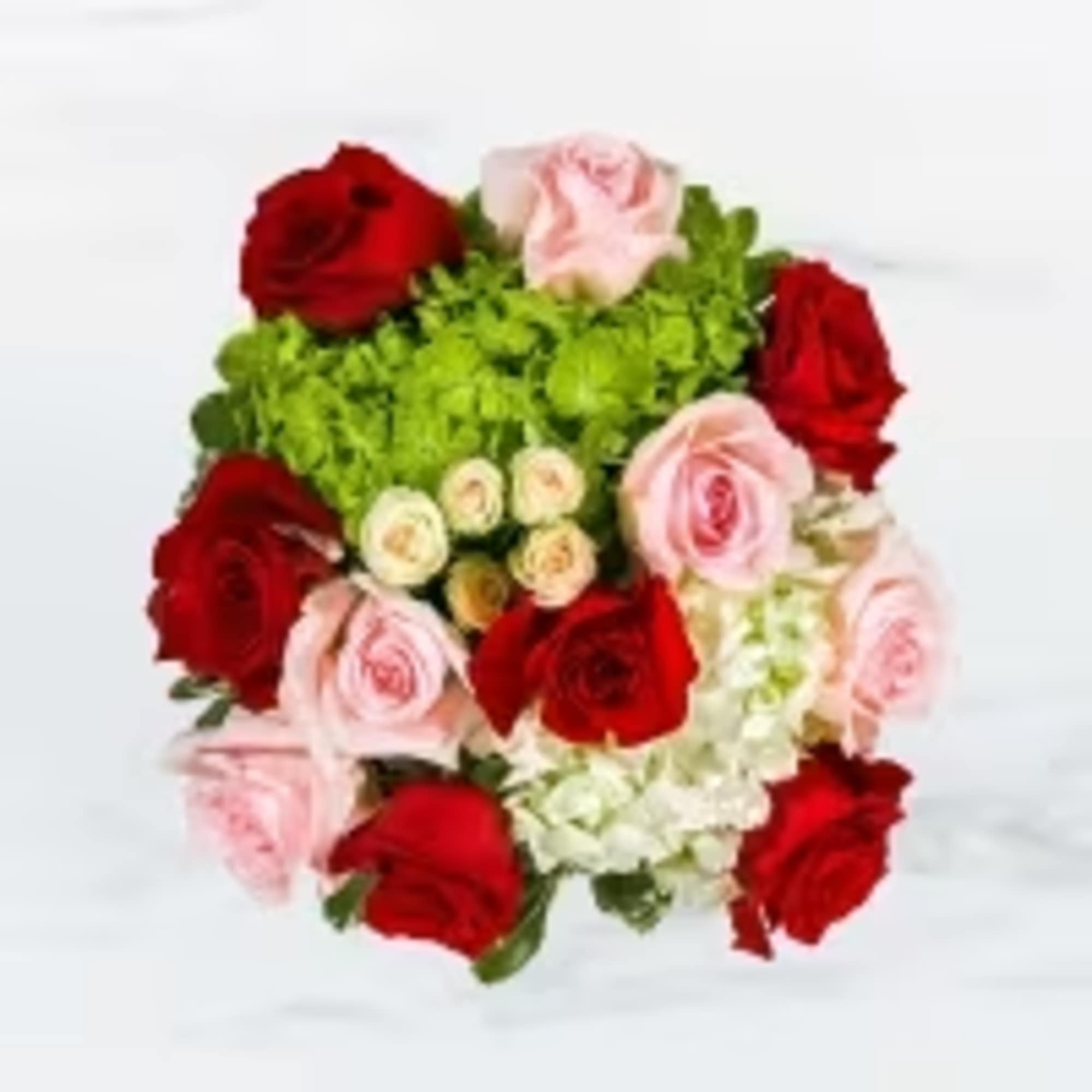 This arrangement includes blush pink roses, red roses, blush spray roses, white