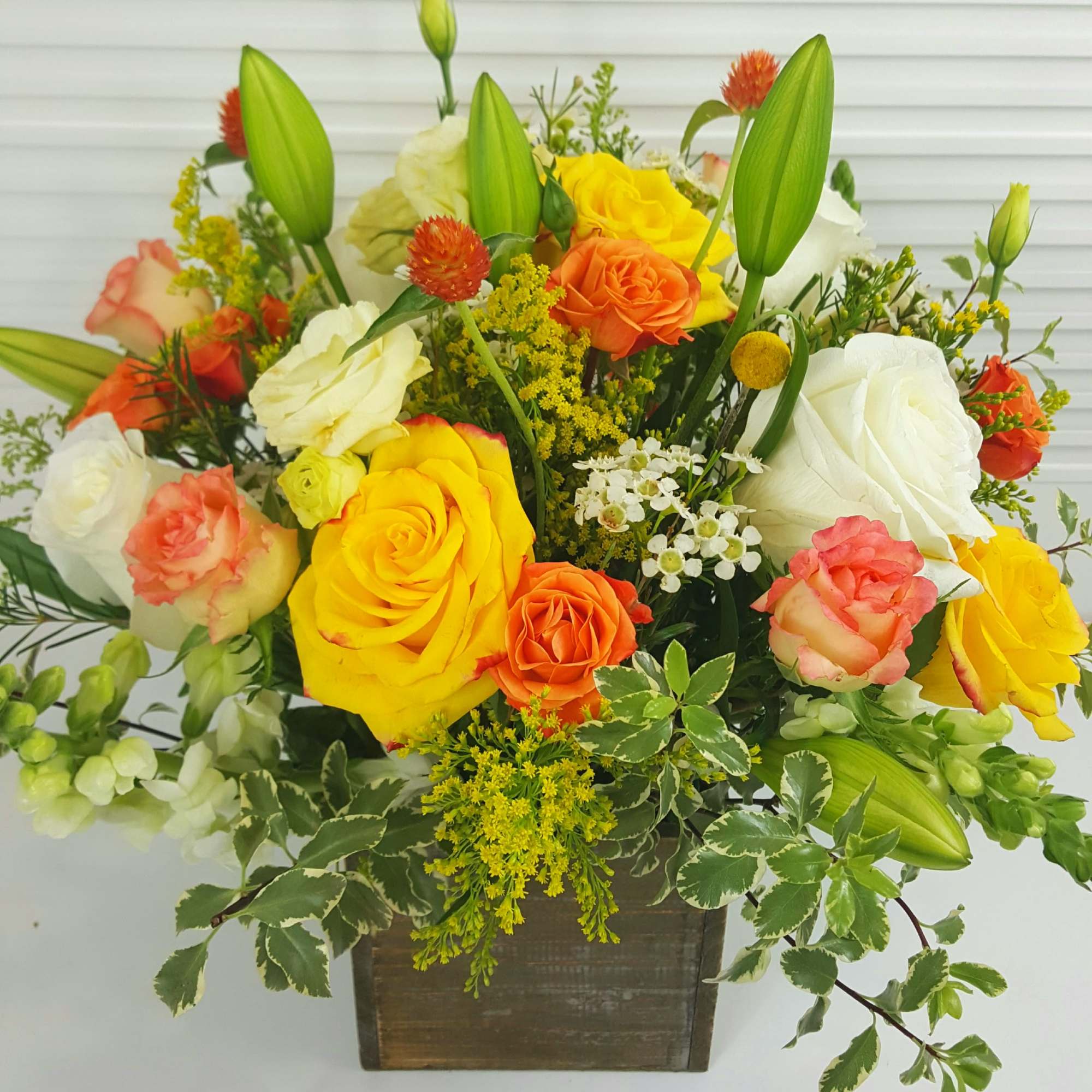 White and Yellow rosrs, snap, lilies, peach african roses, solidago, waxflower, and