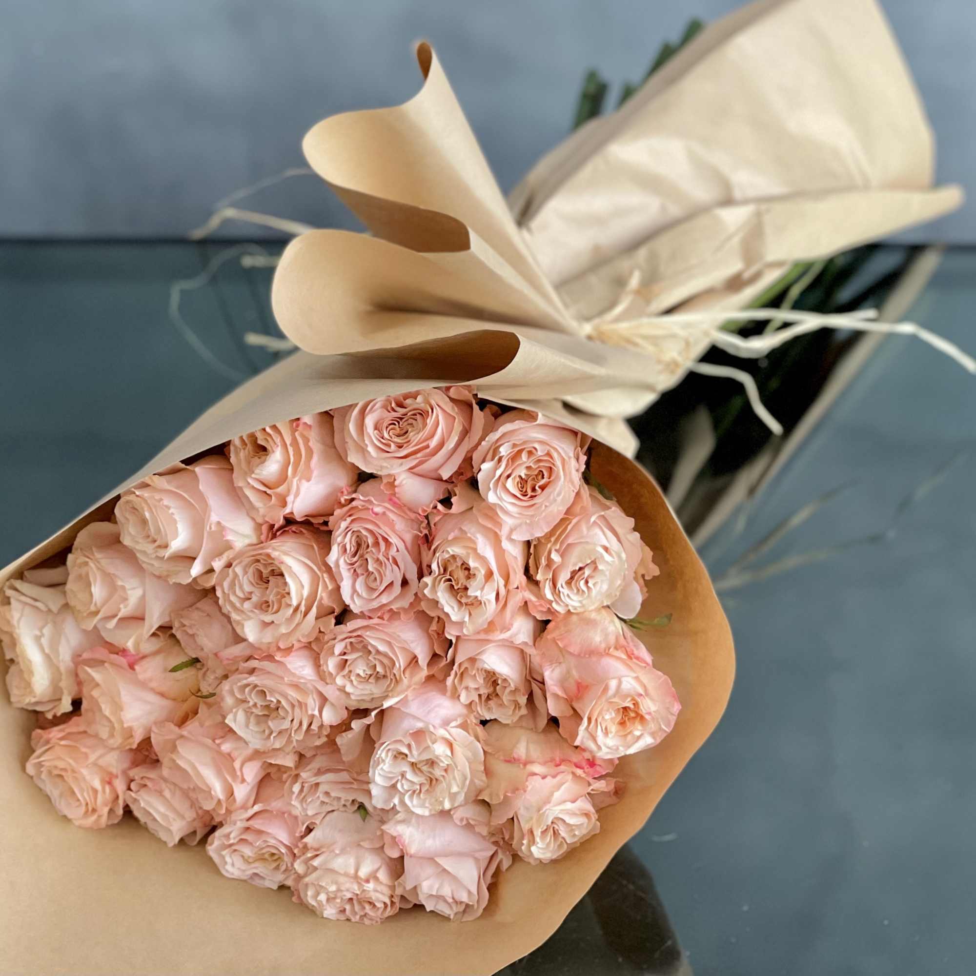 A bouquet of 24 peach garden roses creates a charming and elegant