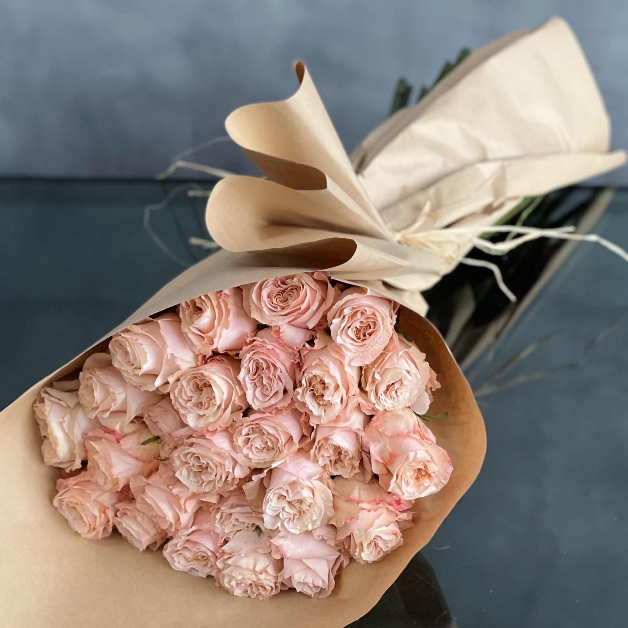A bouquet of 24 peach garden roses creates a charming and elegant