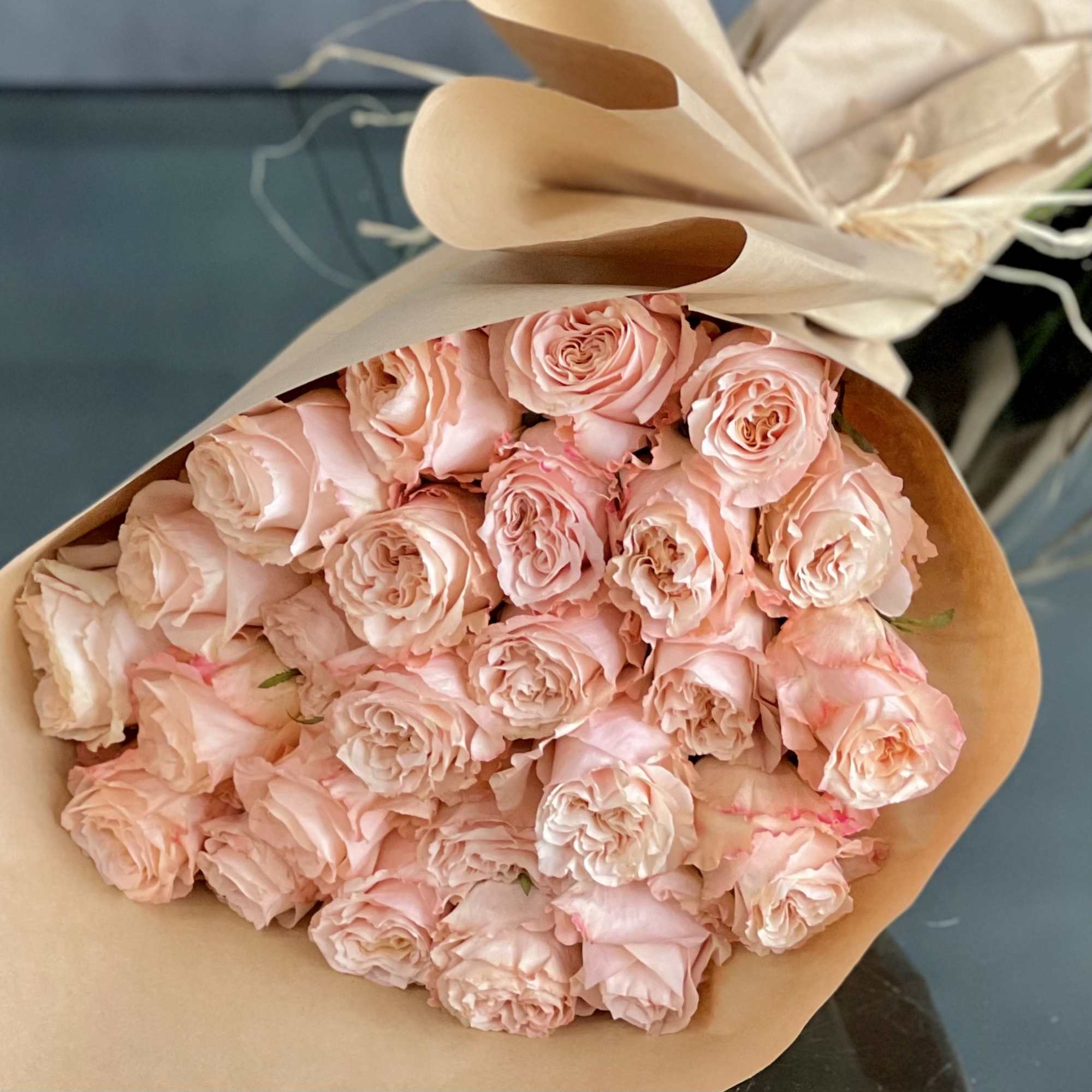 A bouquet of 24 peach garden roses creates a charming and elegant