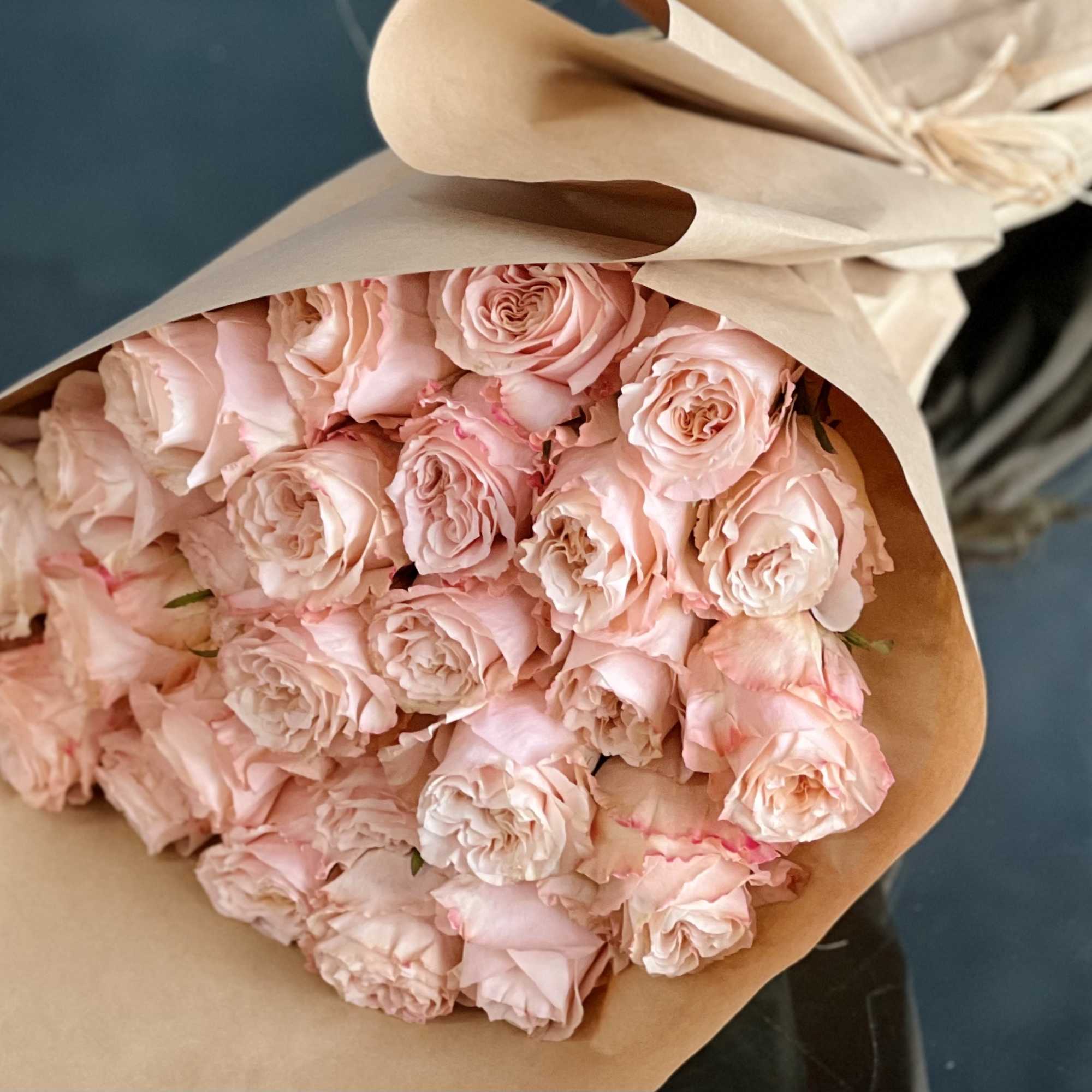 A bouquet of 24 peach garden roses creates a charming and elegant