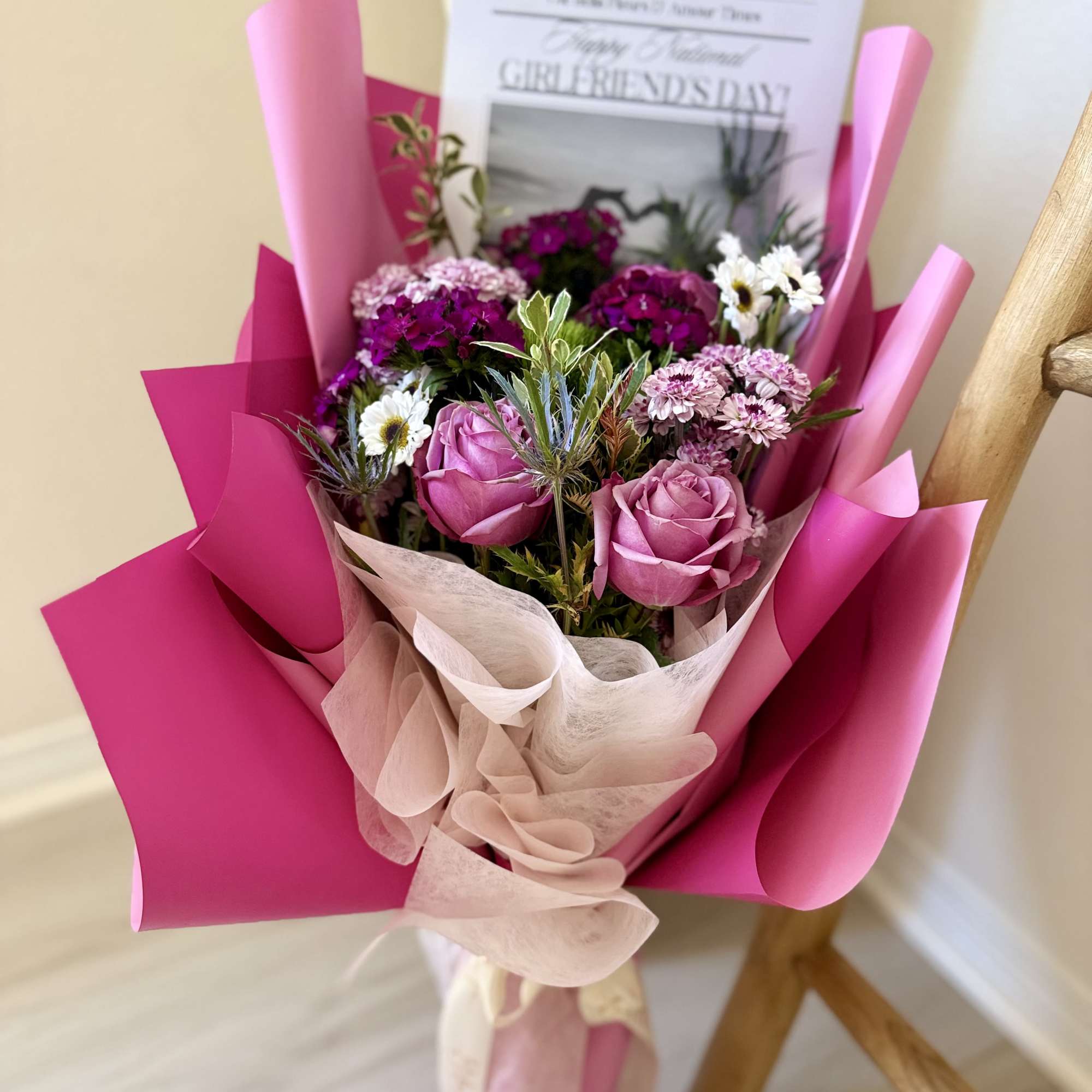 Designers choice mixed florals elegantly arranged in a bouquet with out national