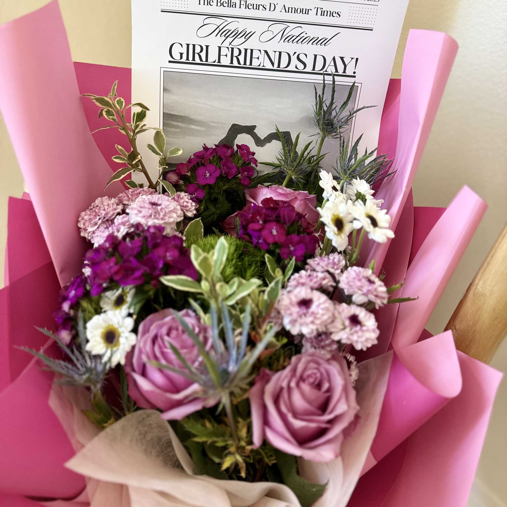 Designers choice mixed florals elegantly arranged in a bouquet with out national