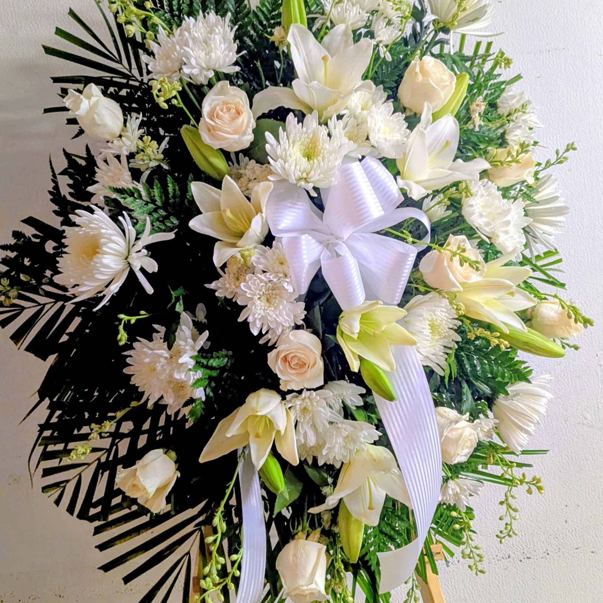 Honor a life beautifully lived with this elegant standing spray, thoughtfully arranged