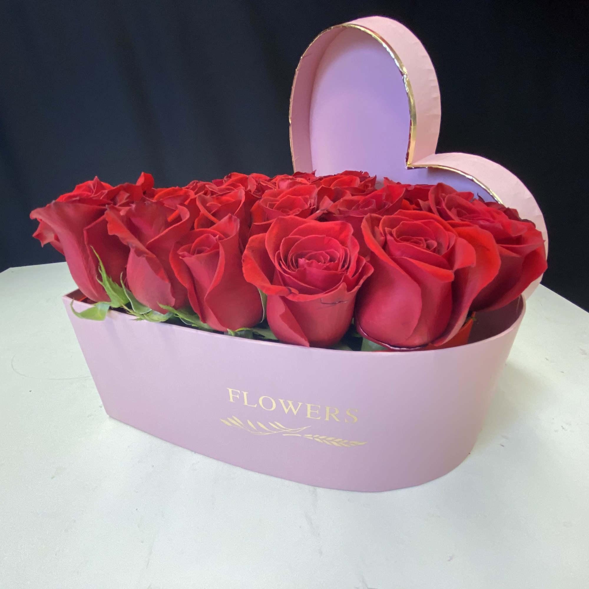 Freshly picked red roses arranged in a heart shape box.