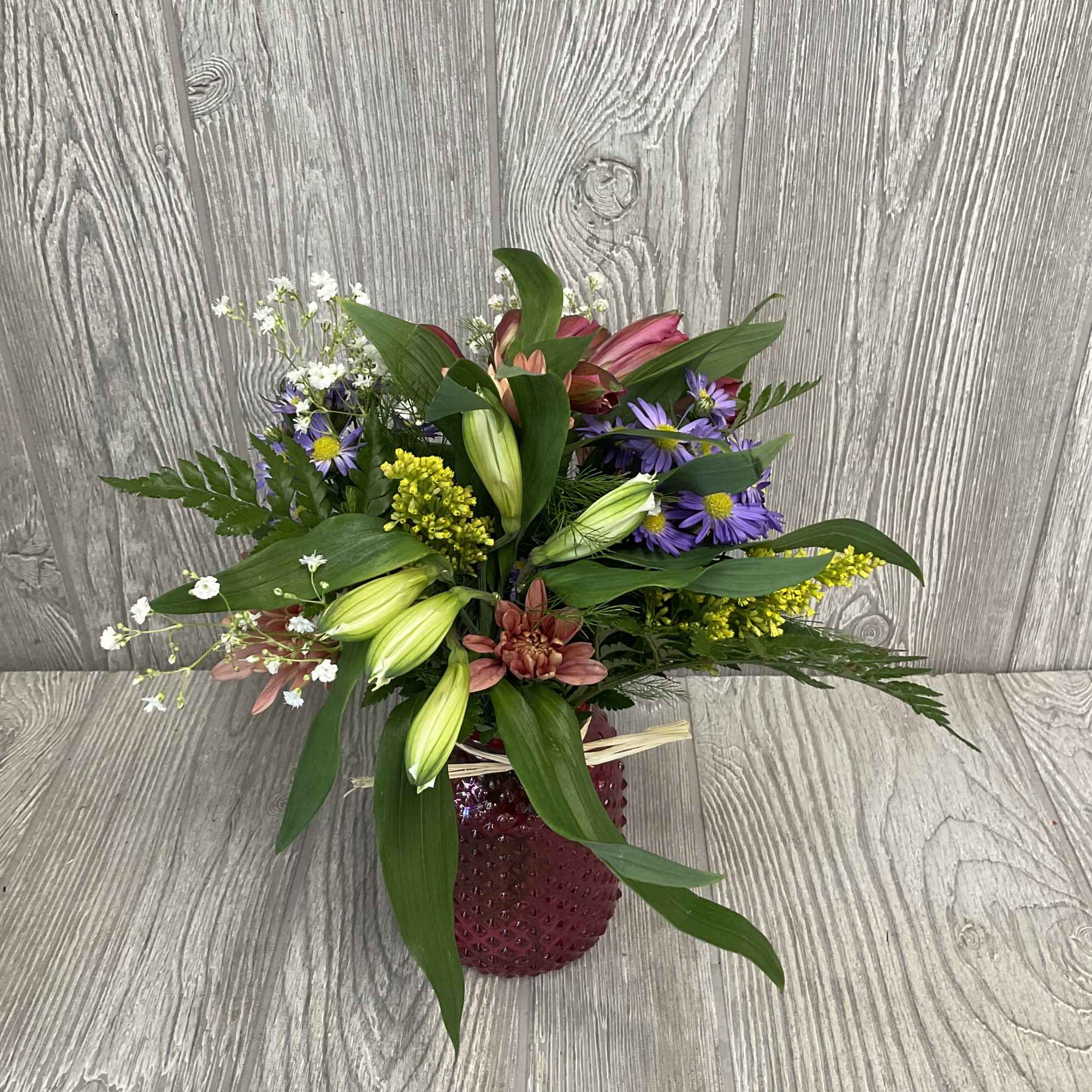 Wildflower arrangement designed to look like the flowers were fresh picked along Wildflower arrangement designed to look like the flowers were fresh picked along