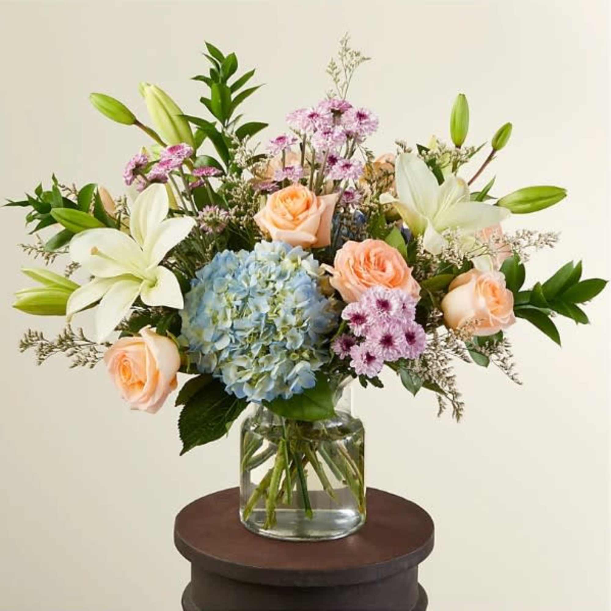 A beautiful arrangement of calming colors pairing perfectly with peach-colored flowers. Available A beautiful arrangement of calming colors pairing perfectly with peach-colored flowers. Available