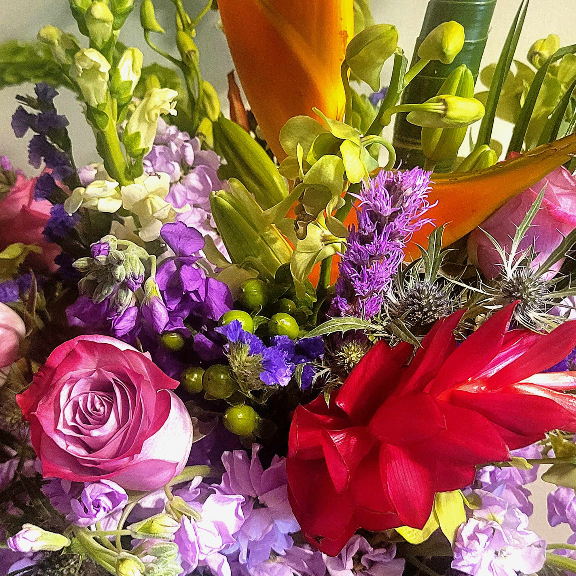 A beautiful design, in a glass sphere where tropical and in-season blooms