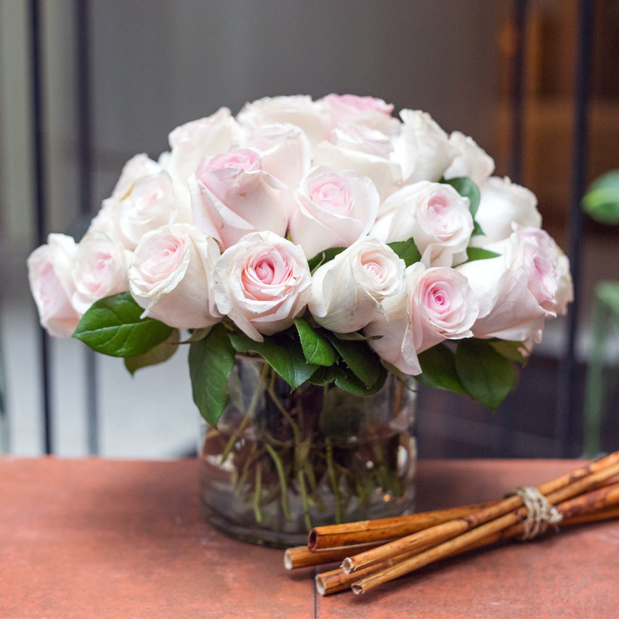 This rose arrangement is artfully designed in a large clear glass bowl. This rose arrangement is artfully designed in a large clear glass bowl.