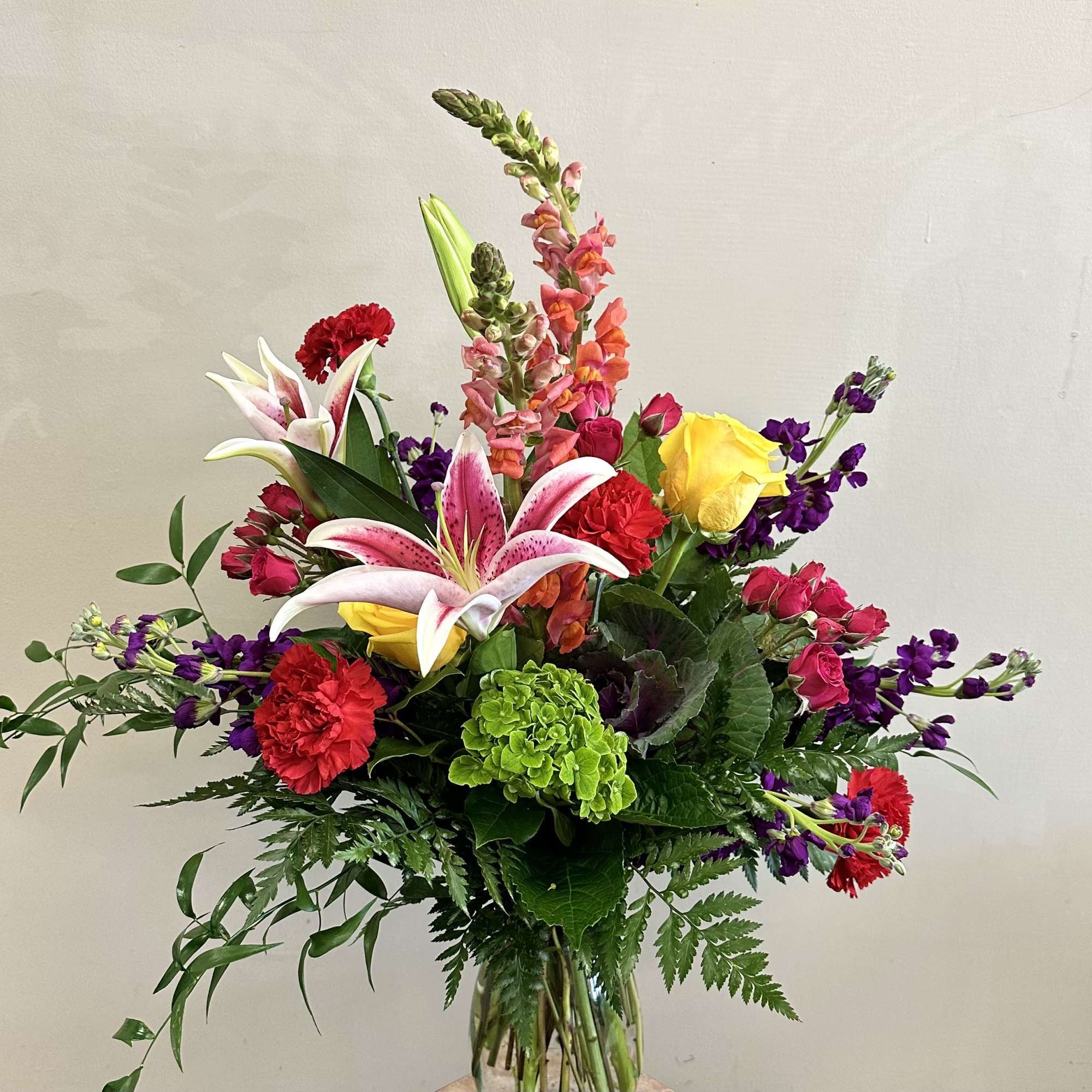 A gorgeous and bright mix of flowers that include stargazer lilies, mini