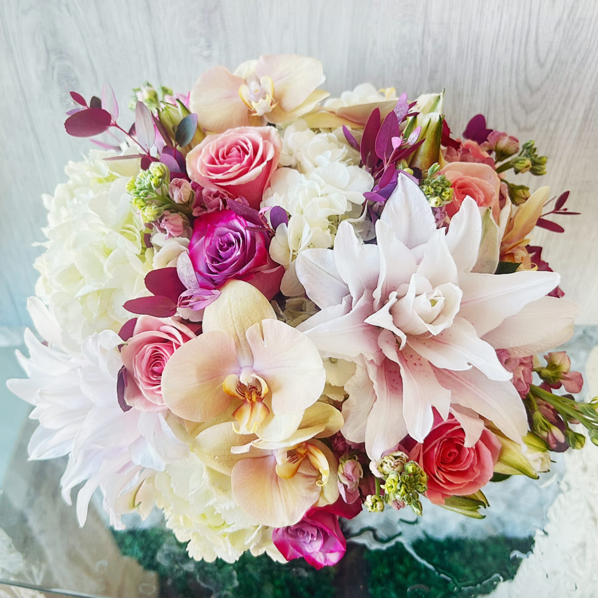 An exquisite bouquet crafted with creamy white hydrangeas, pink and purple roses