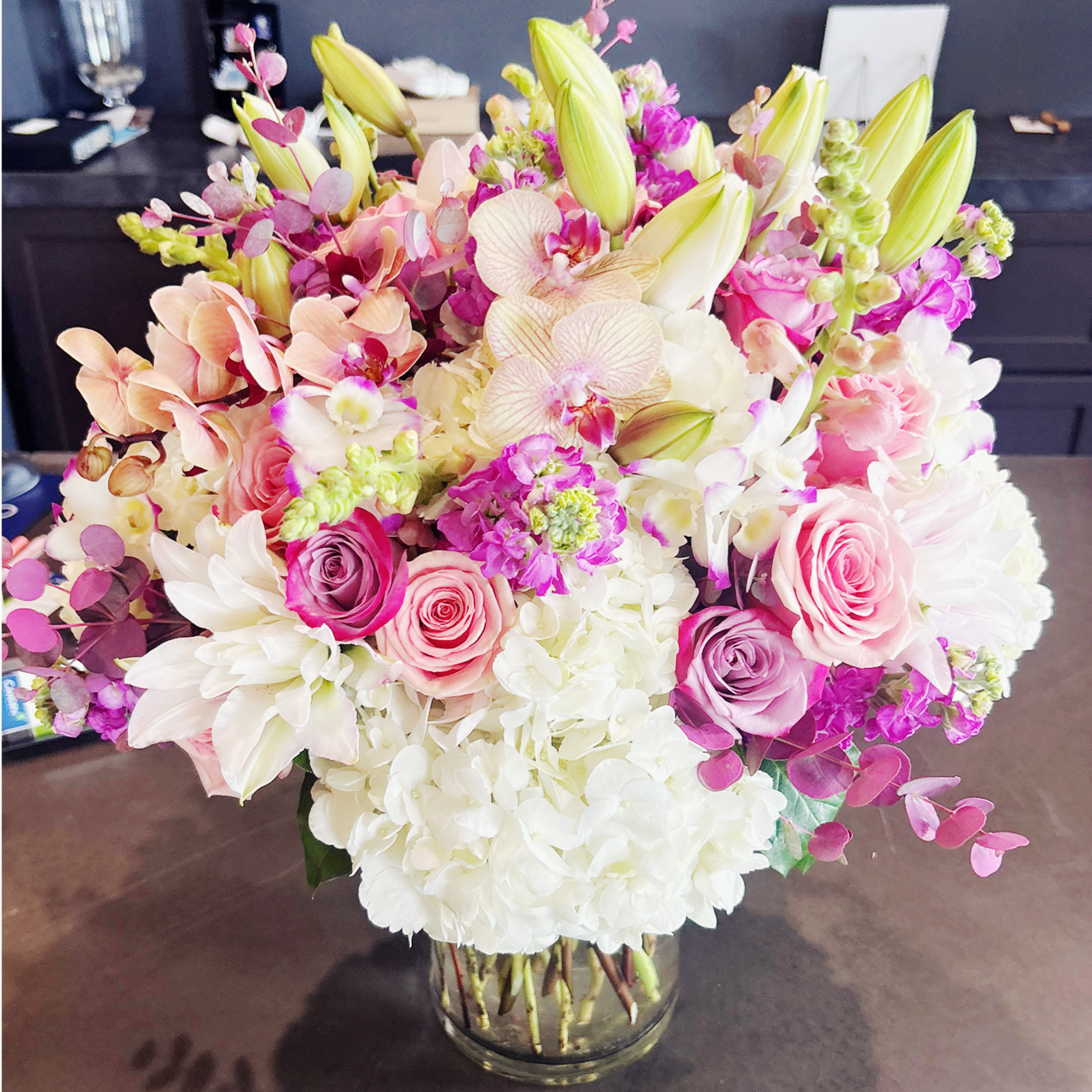An exquisite bouquet crafted with creamy white hydrangeas, pink and purple roses