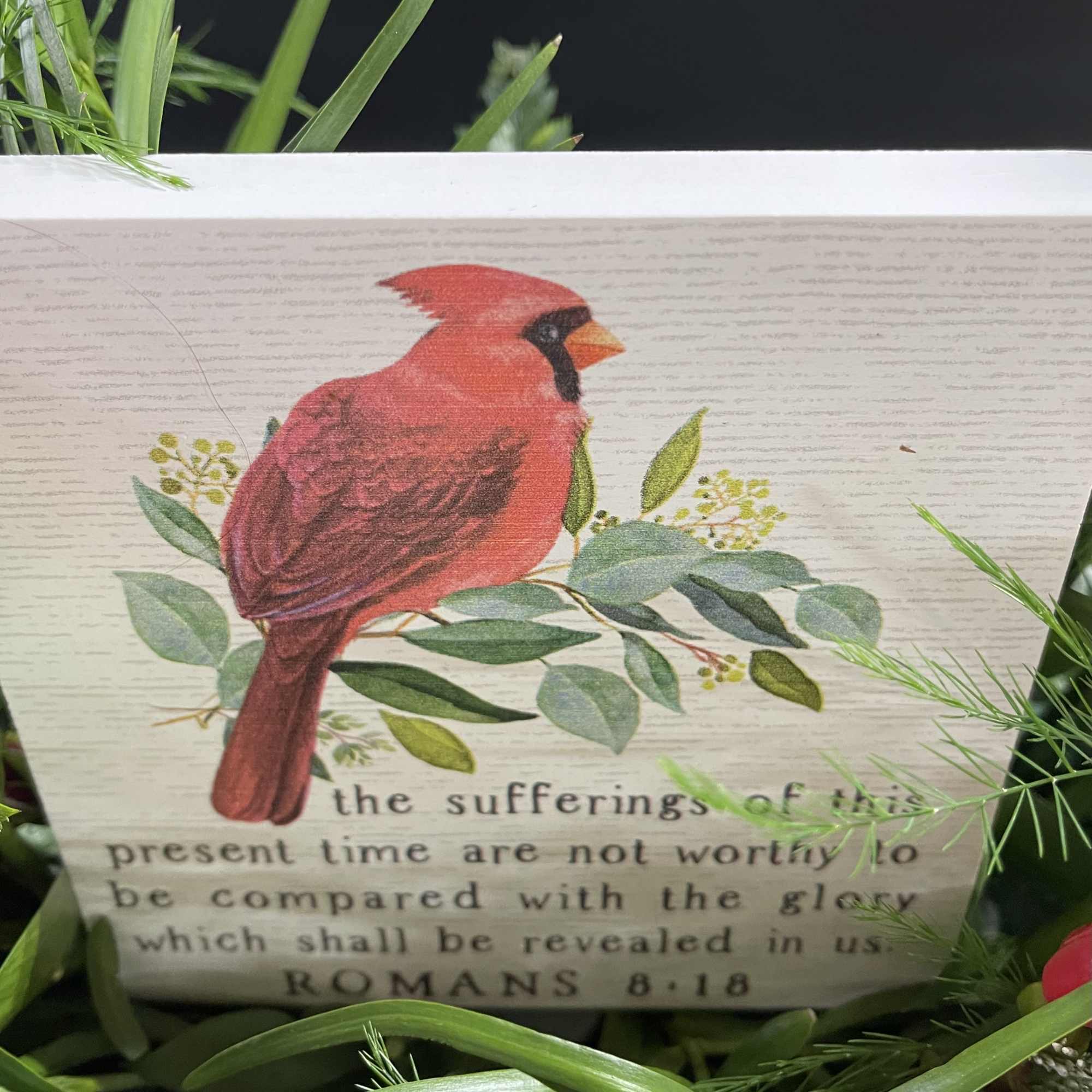 Cardinal Sympathy block surrounded by flowers.  A beautiful arrangement to send