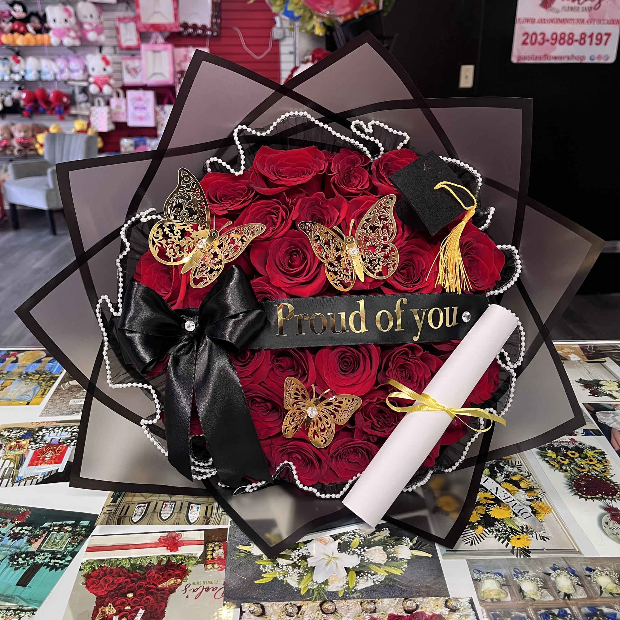 24 red long stem roses with with graduation accessories. Please note color