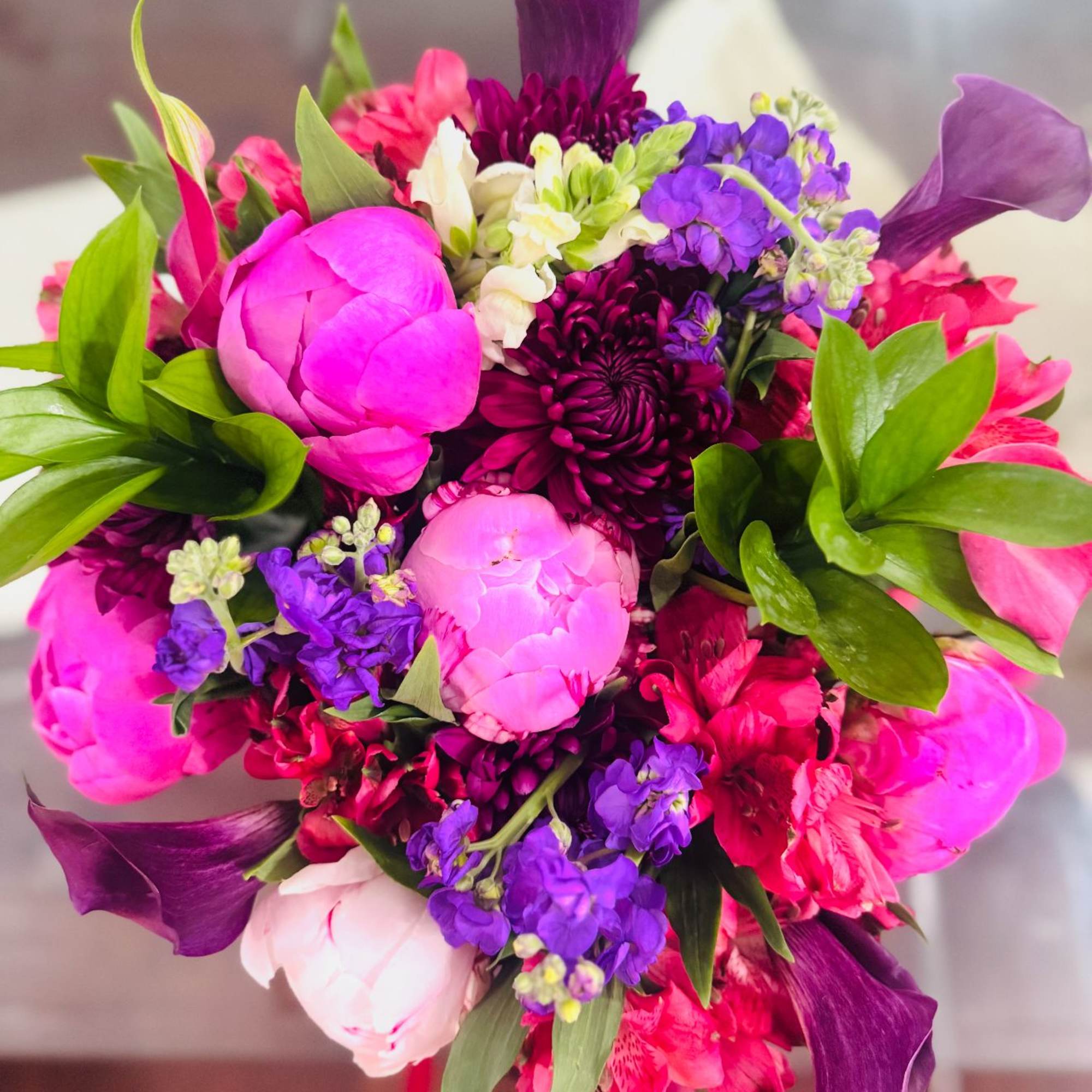Beautiful Bouquet with peonies and different types of flowers. 
The purple bouquet
