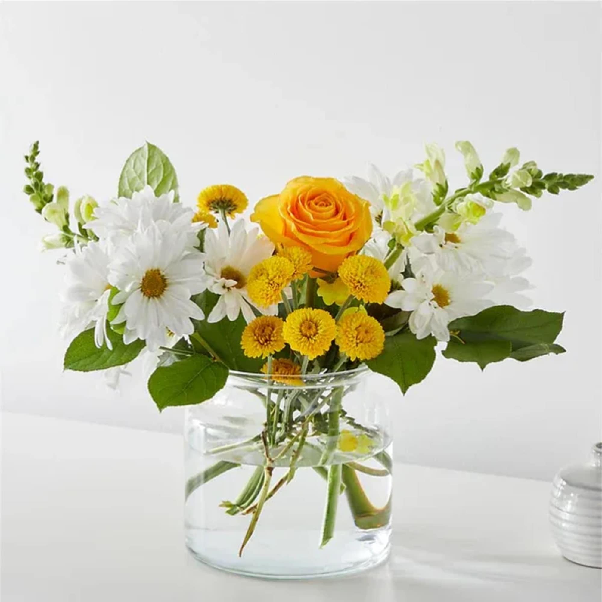 Greet the morning with fresh yellow snapdragons, white daisies, and pink carnations