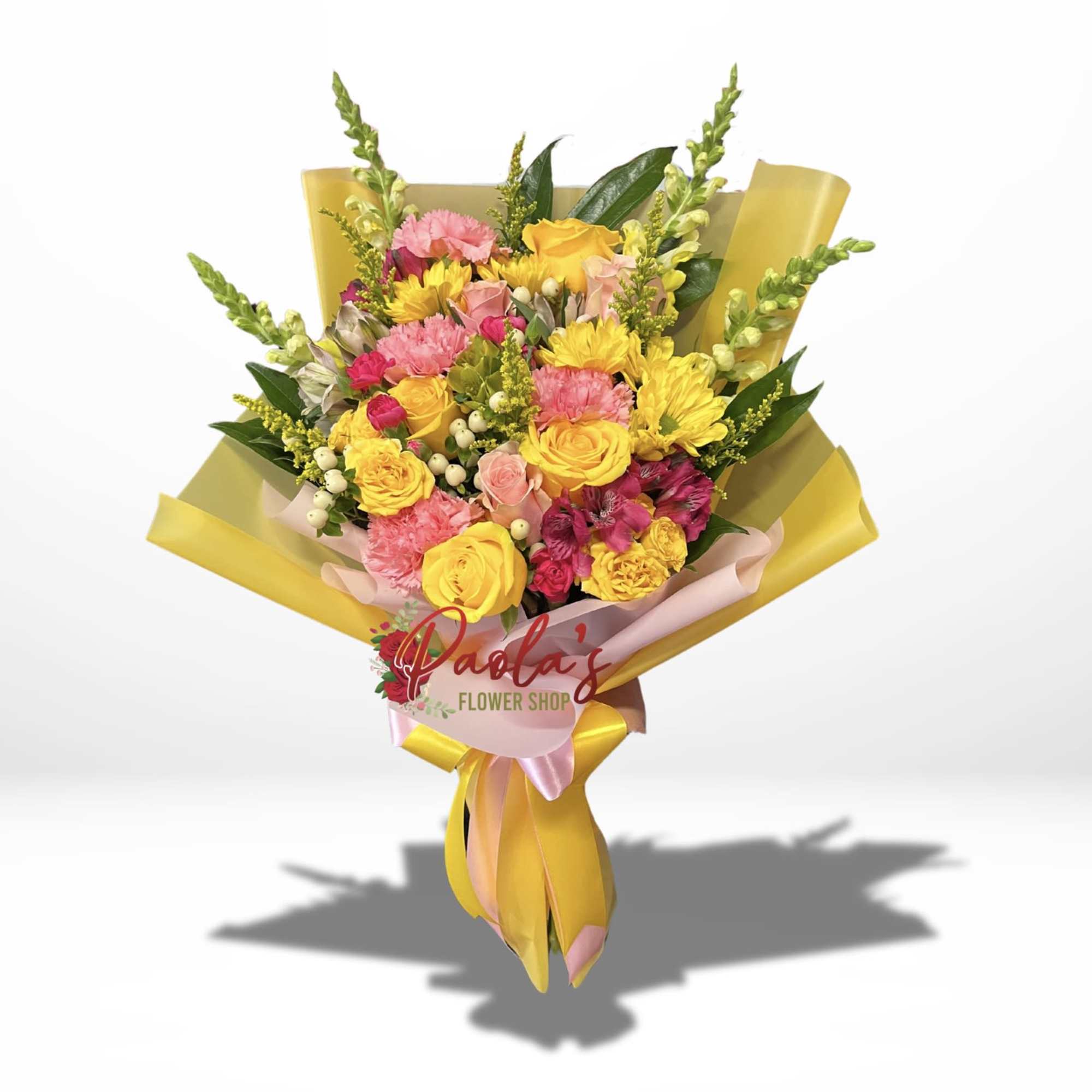 This charming bouquet features a vibrant mix of yellow and pink flowers.