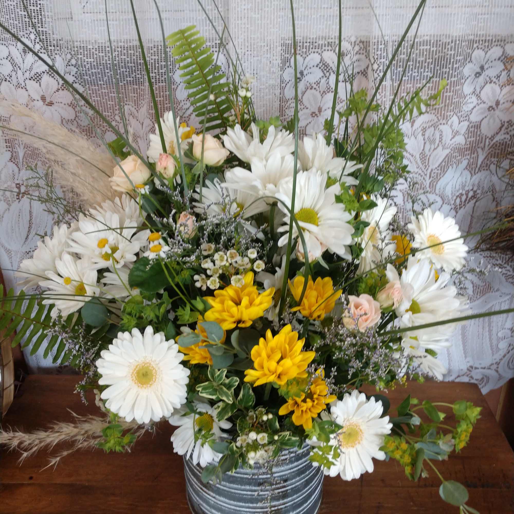 A galvanized tin container (different than pictured) with assorted white and yellow