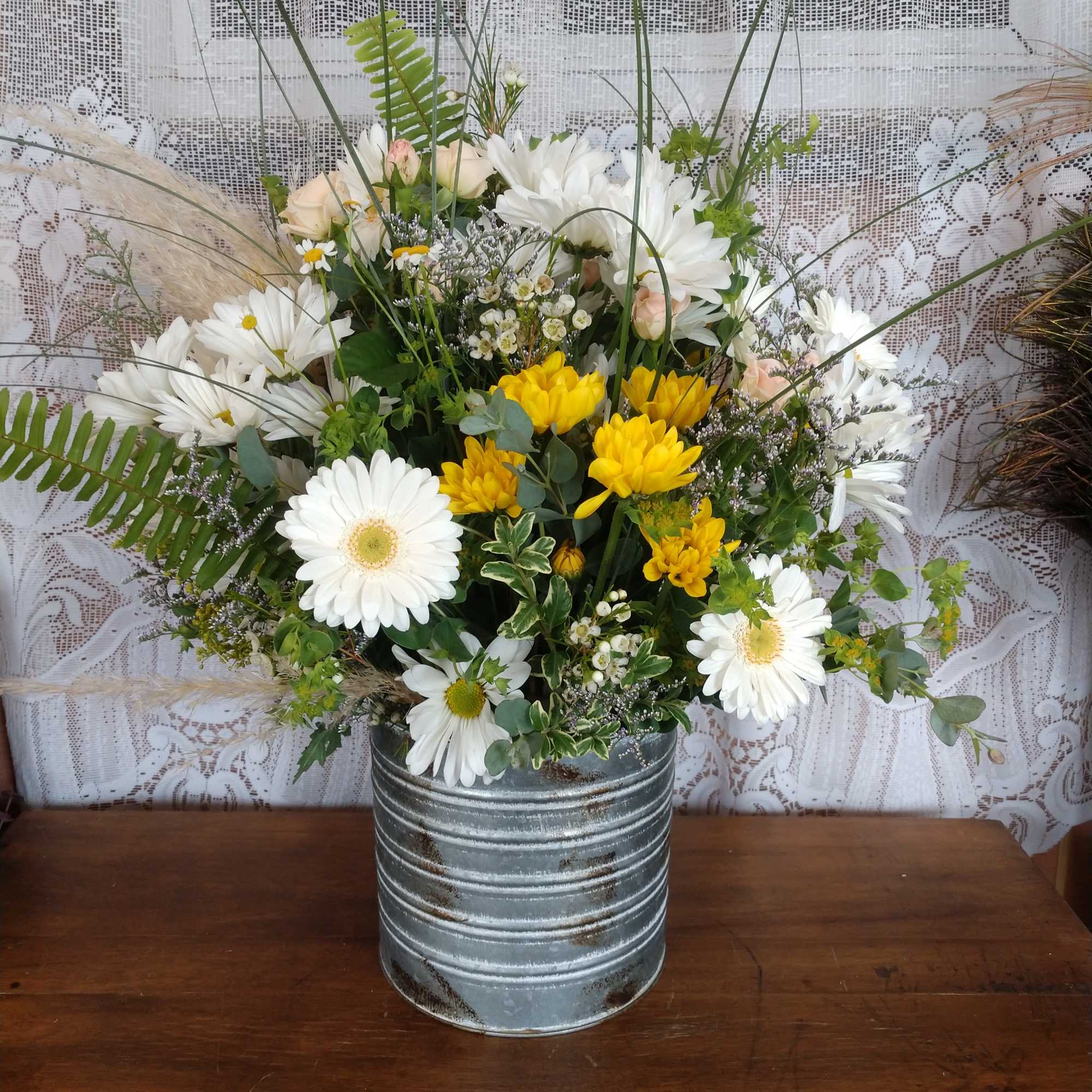 A galvanized tin container (different than pictured) with assorted white and yellow