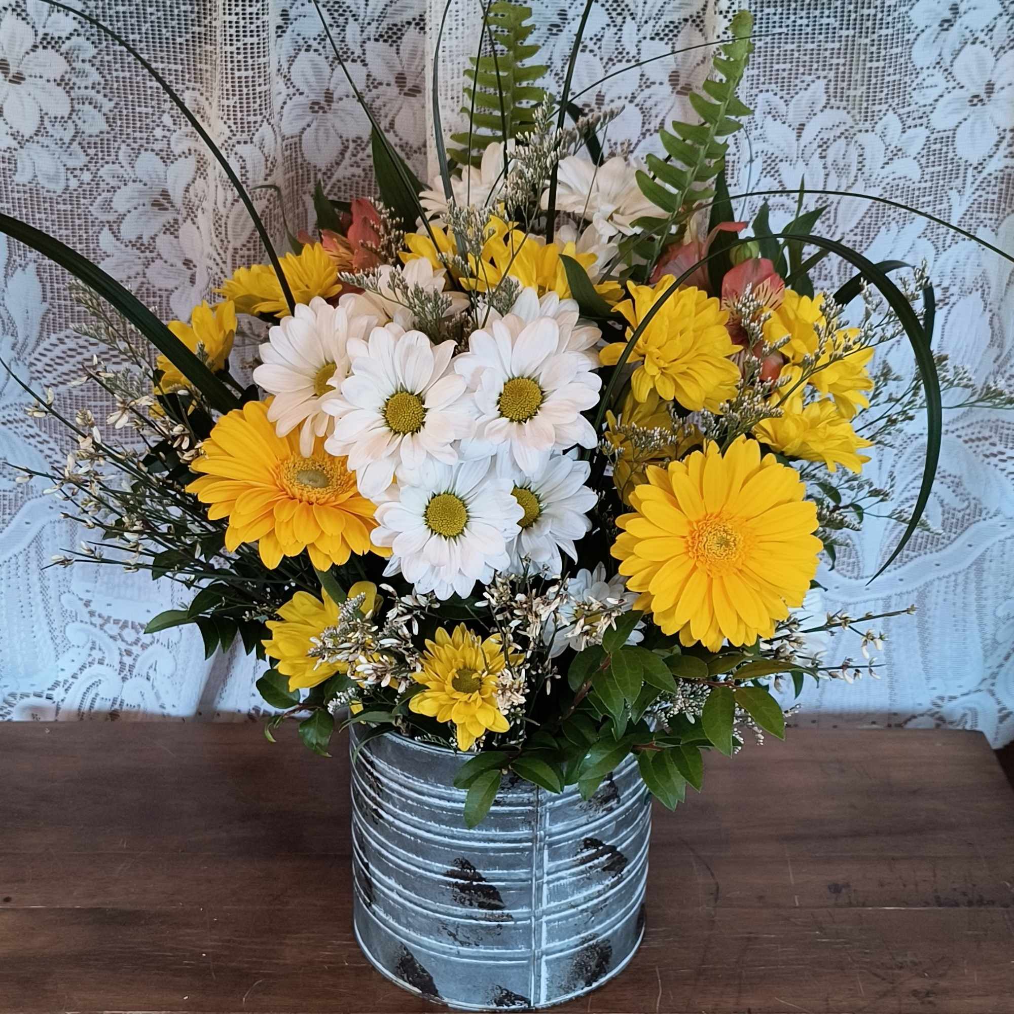 A galvanized tin container (different than pictured) with assorted white and yellow