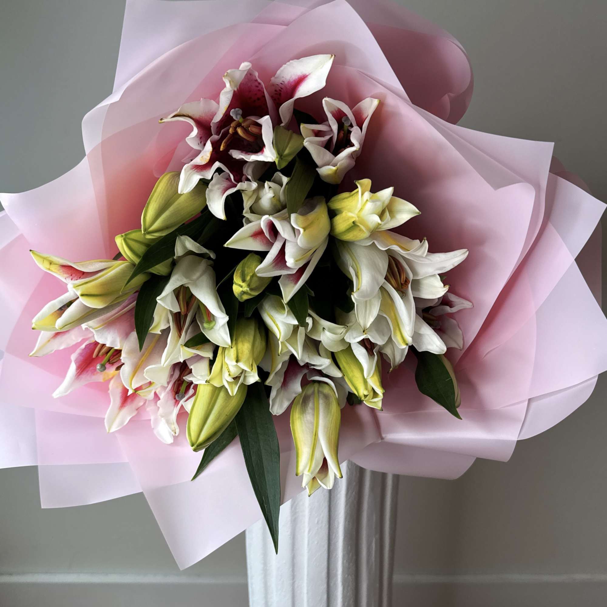 A stunning arrangement of majestic, fragrant oriental lilies, elegantly wrapped in delicate