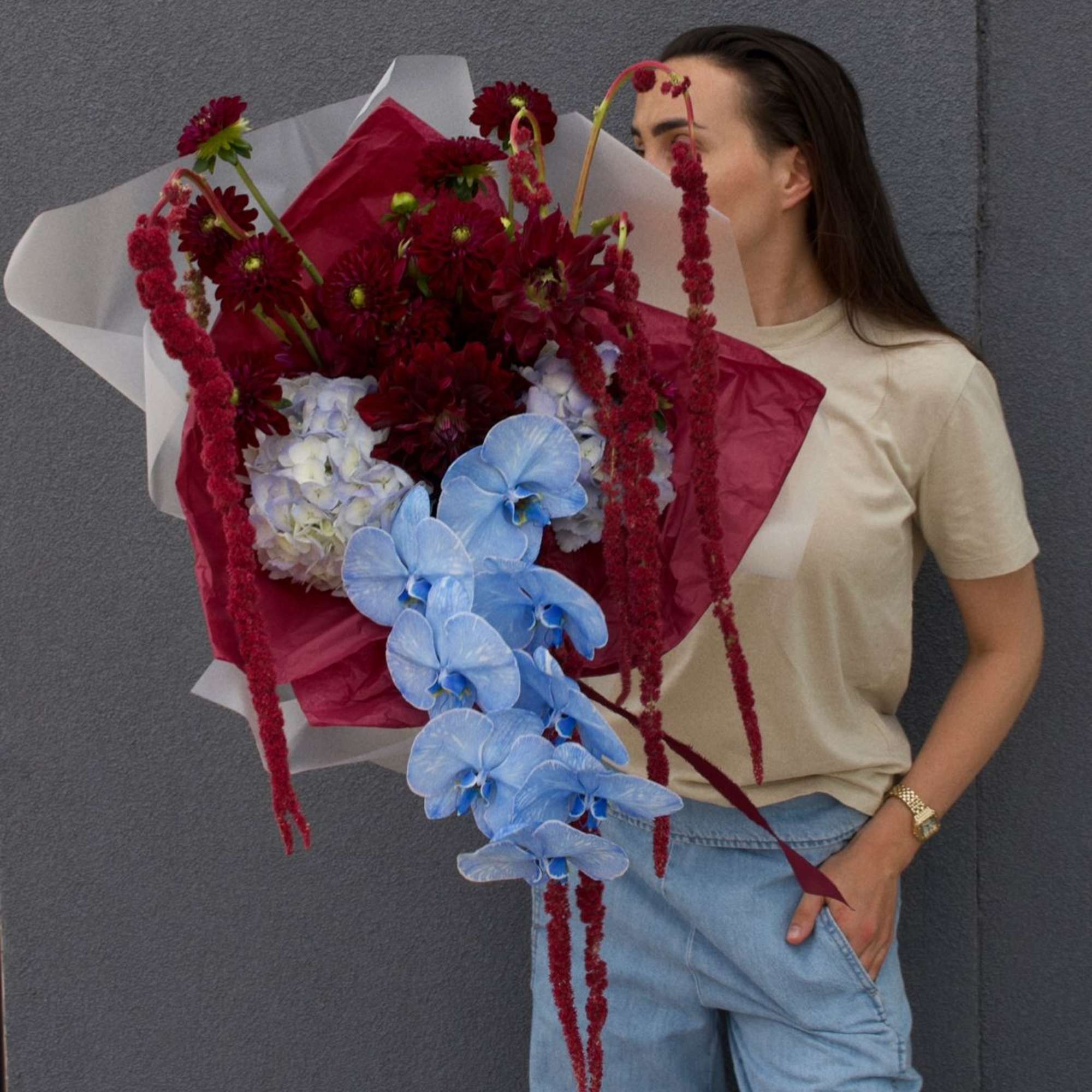 A striking fusion of deep burgundy dahlias and cascading amaranthus, electrified by