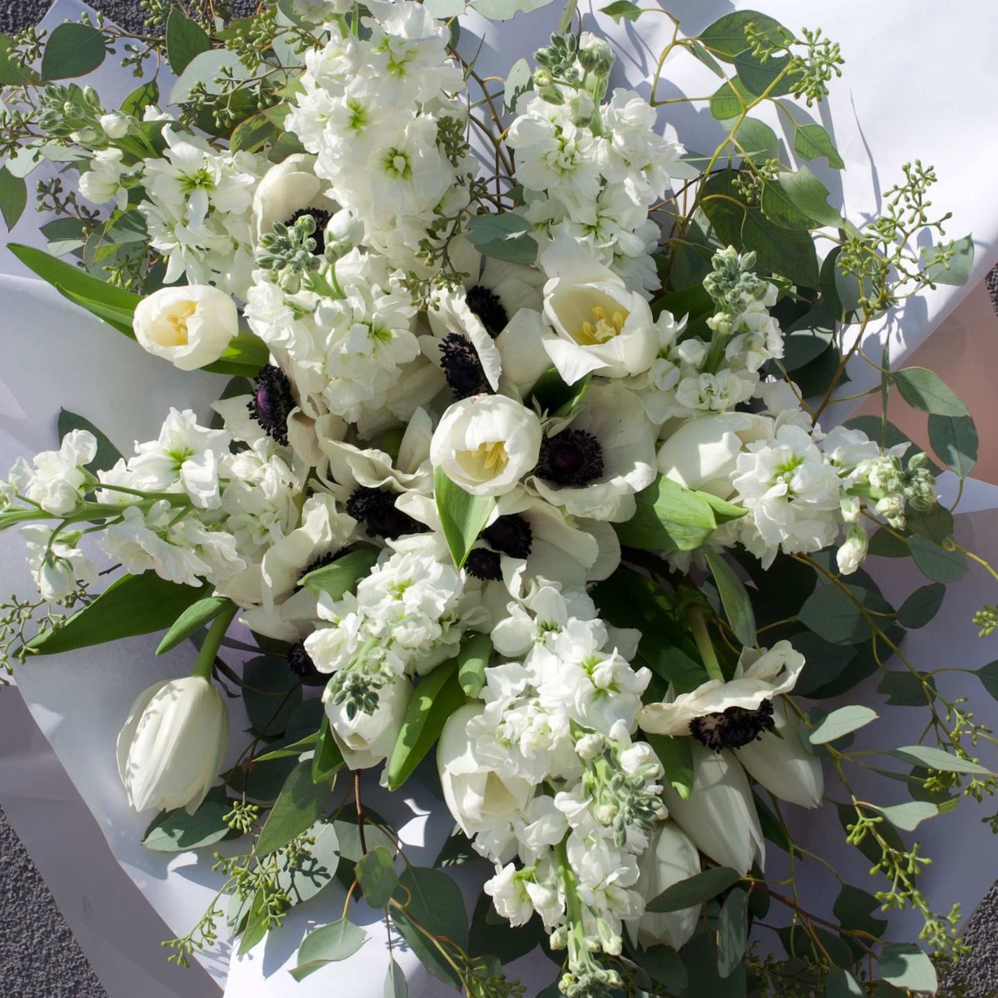 A symphony of white and shadow, this bouquet evokes the quiet drama