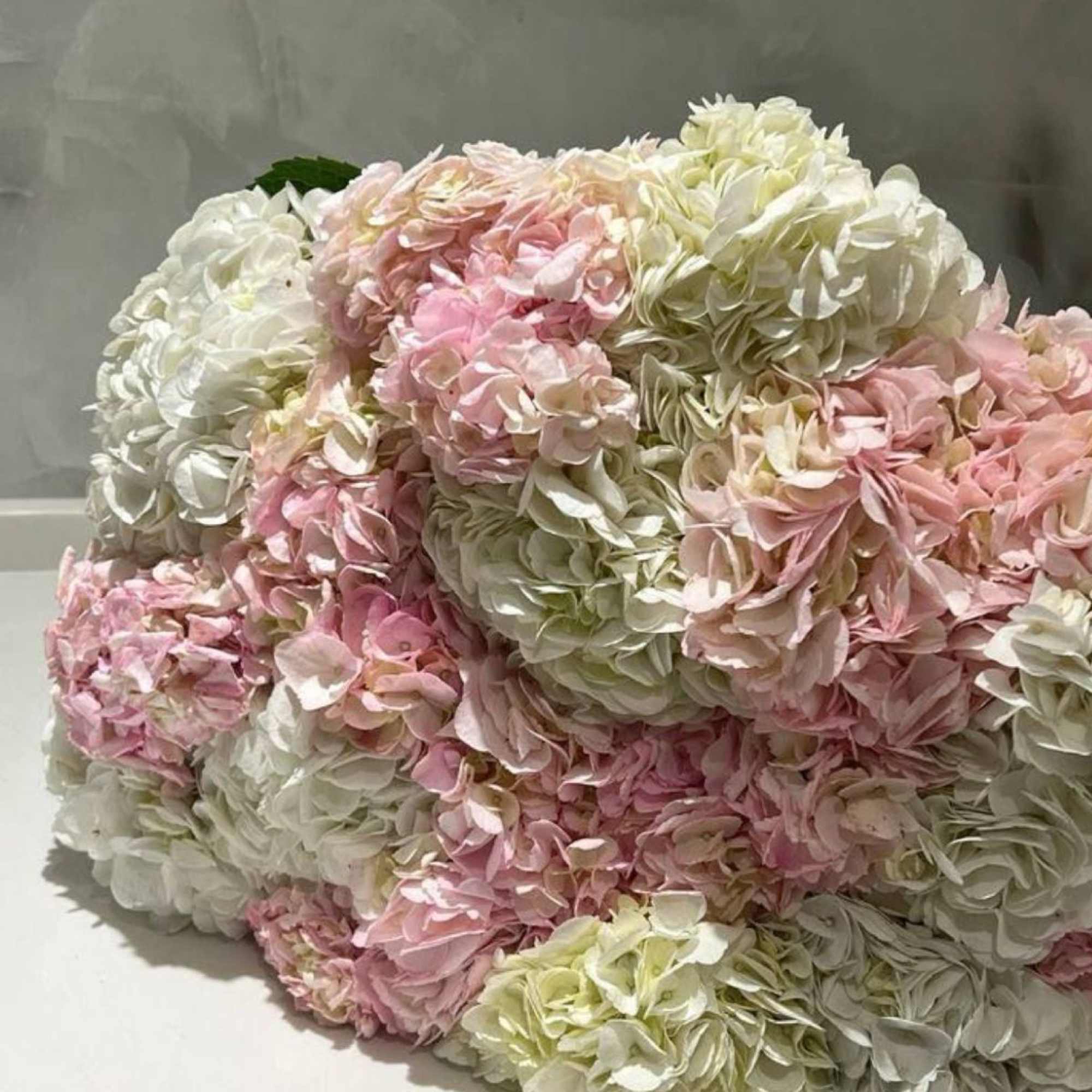 A voluminous bouquet in soft ivory, blush, and pastel hues &mdash; pure