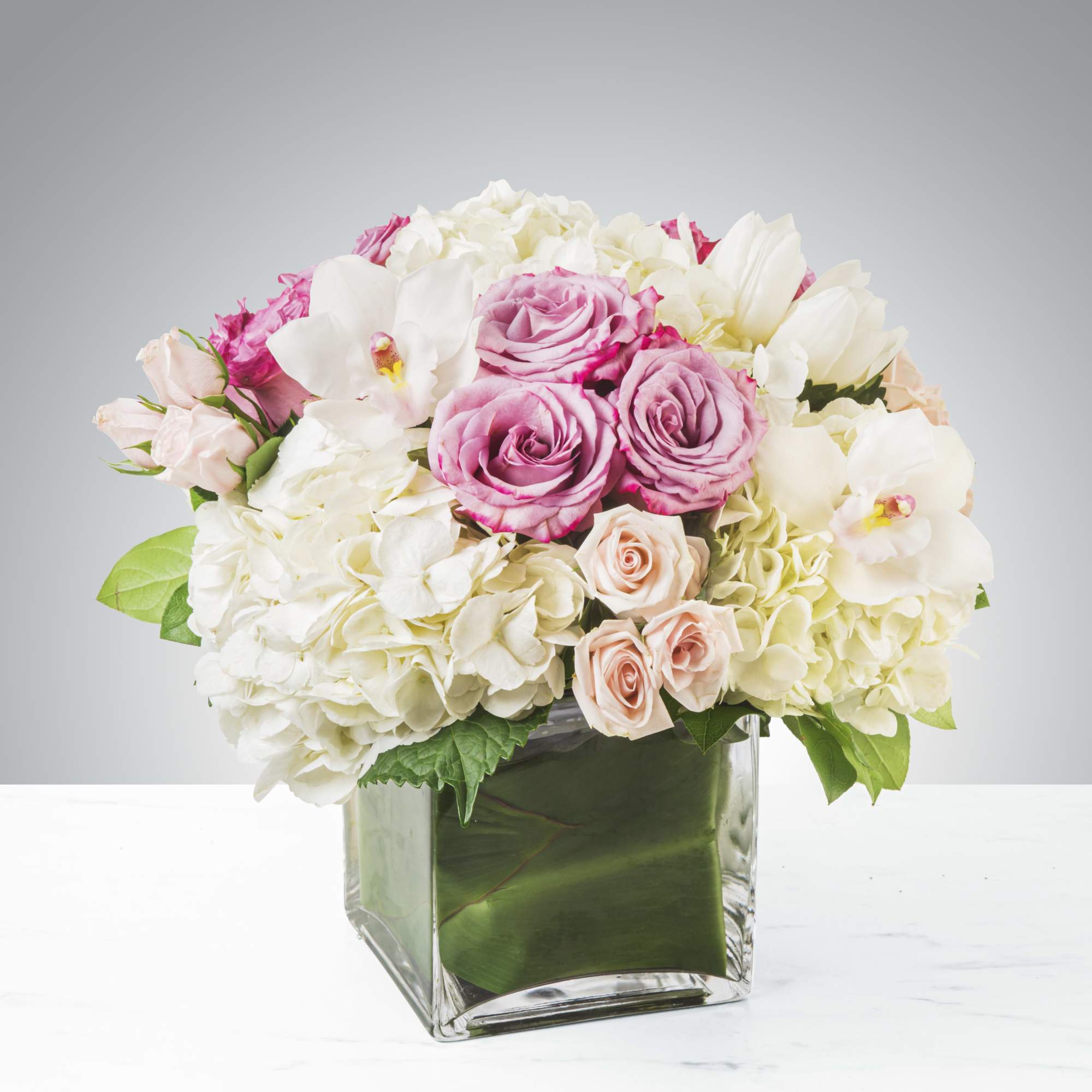 Classic and Beautiful, this large arrangement whispers luxury. Soft pinks, whites and