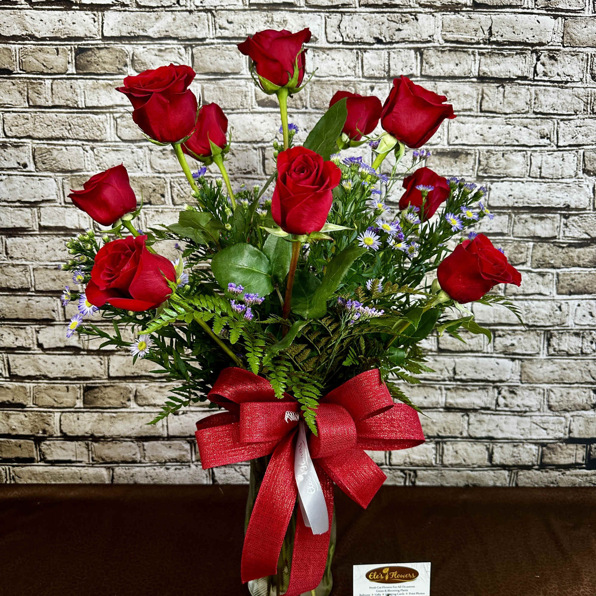 Indulge in classic beauty with our Passionate Roses arrangement, featuring one dozen Indulge in classic beauty with our Passionate Roses arrangement, featuring one dozen