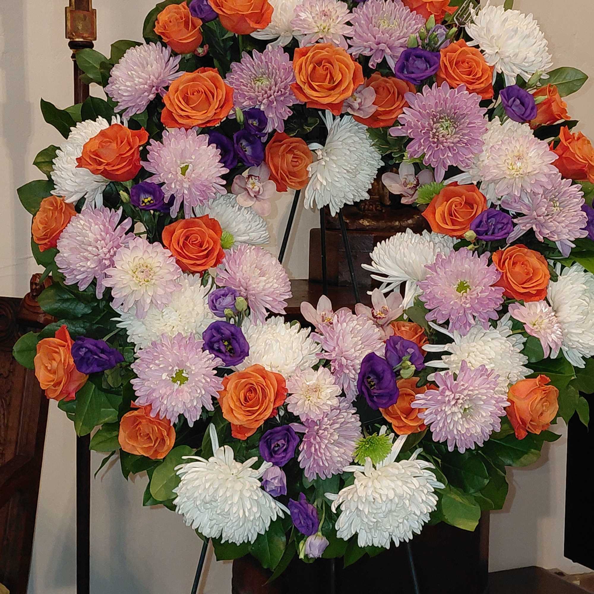 Wreath Designed with assortment of High End Seasonal Flowers & Fancy Greens. Wreath Designed with assortment of High End Seasonal Flowers & Fancy Greens.