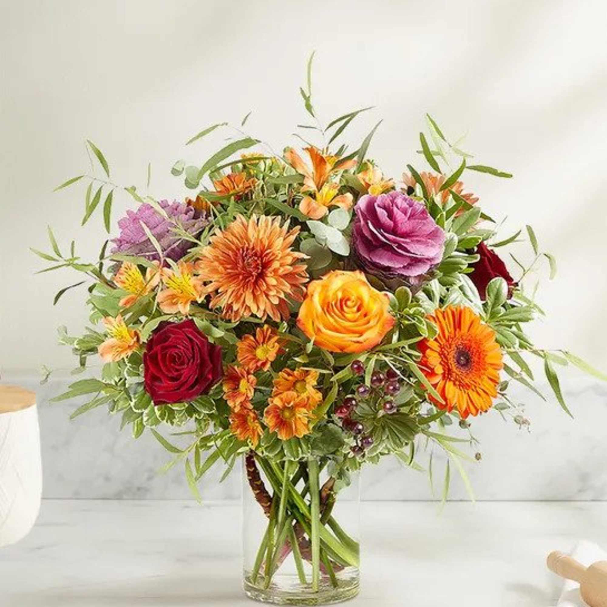 An abundant, garden-inspired mix of blooms is gathered with natural accents inside