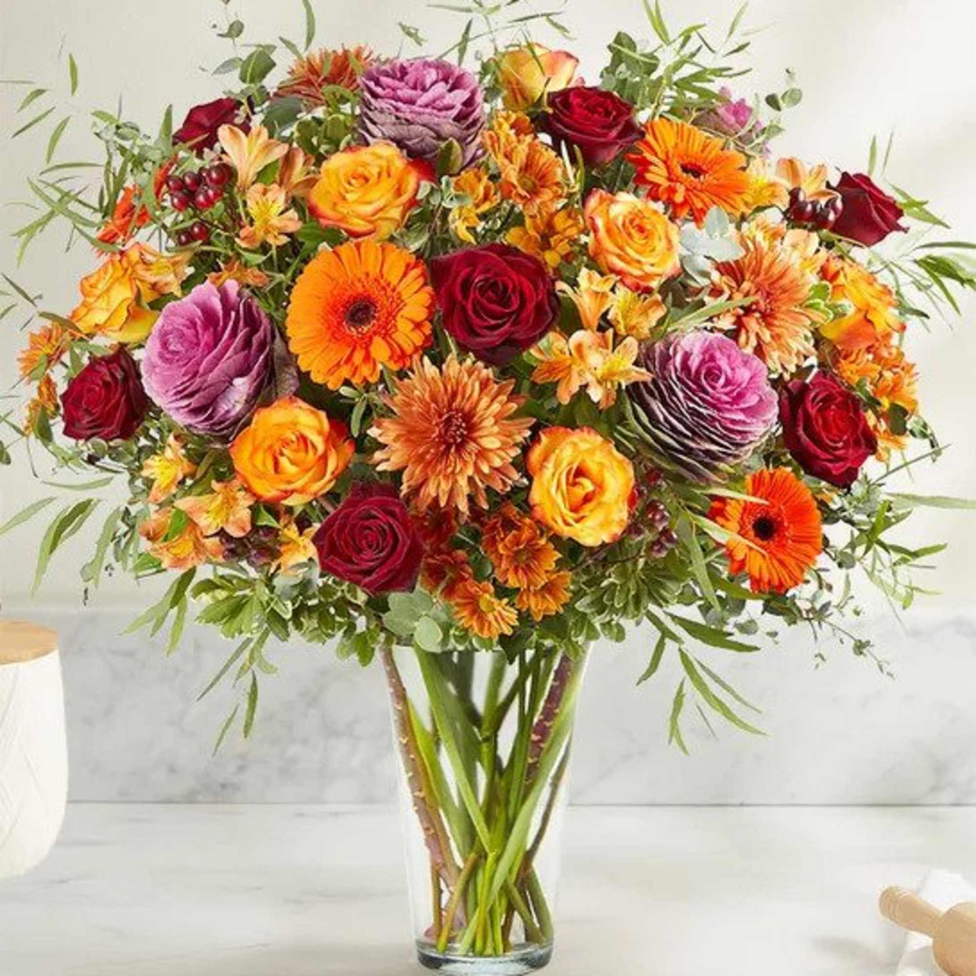 An abundant, garden-inspired mix of blooms is gathered with natural accents inside