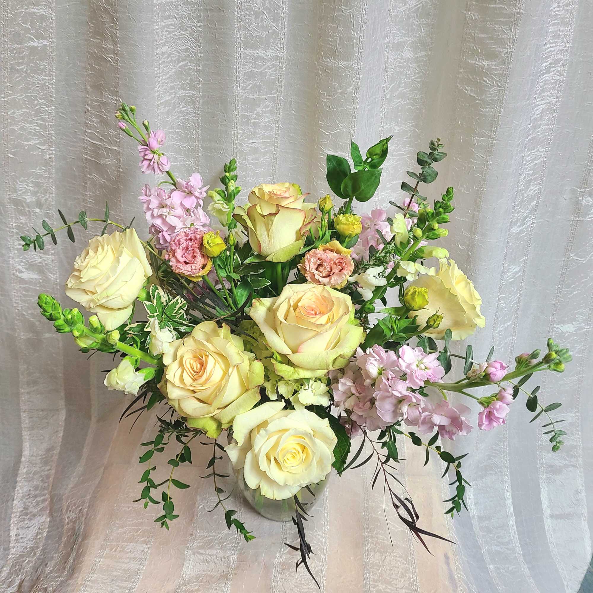 Romantic pastels and delicate scents. Half dozen roses with added mixed blooms.
